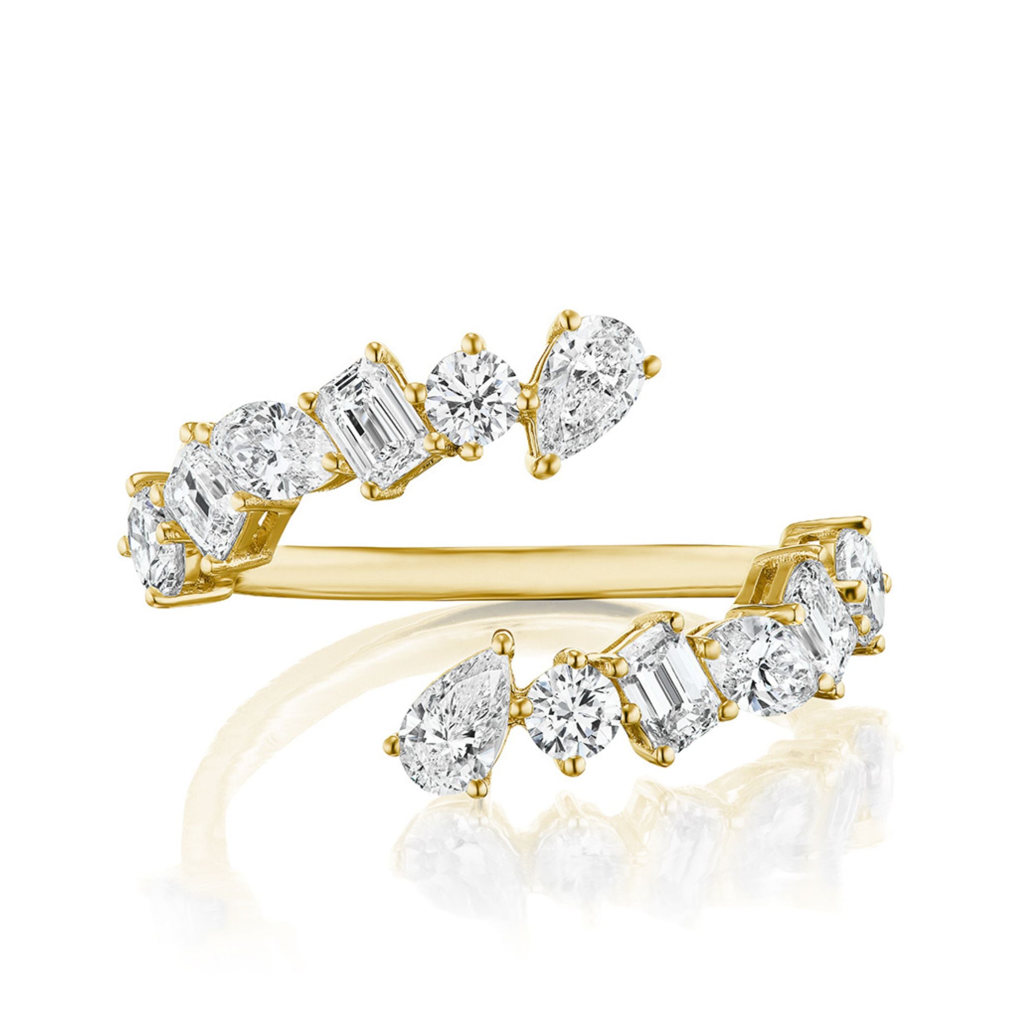 The Wraparound Ring with Mixed Shape Diamonds is crafted in 18K gold and features round, emerald, and pear-shaped diamonds set asymmetrically along the band's top.