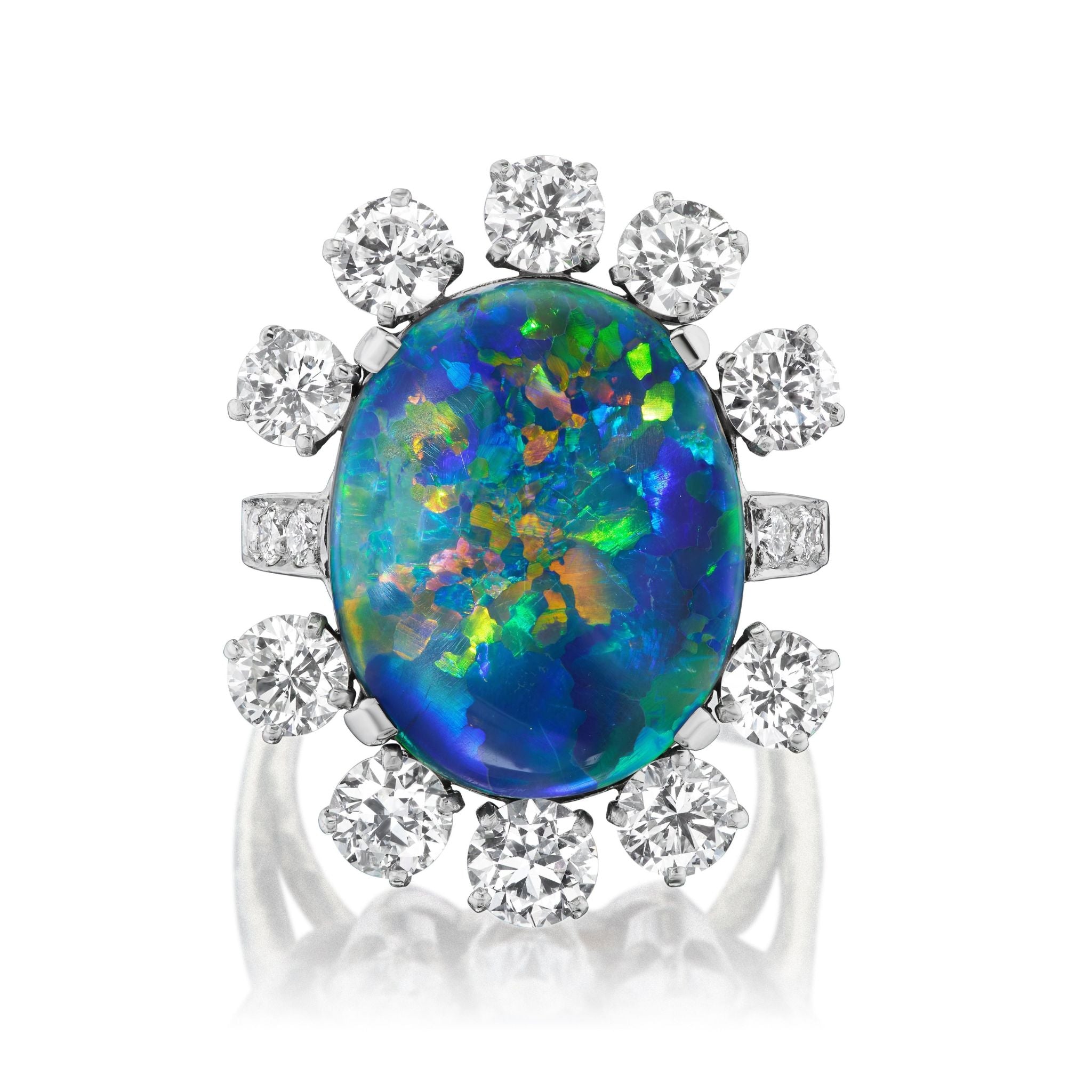 The Sunburst Oval Opal Ring features vibrant blue, green, and orange hues, accented by round brilliant diamonds and pavé detailing in a refined 18K white gold band.