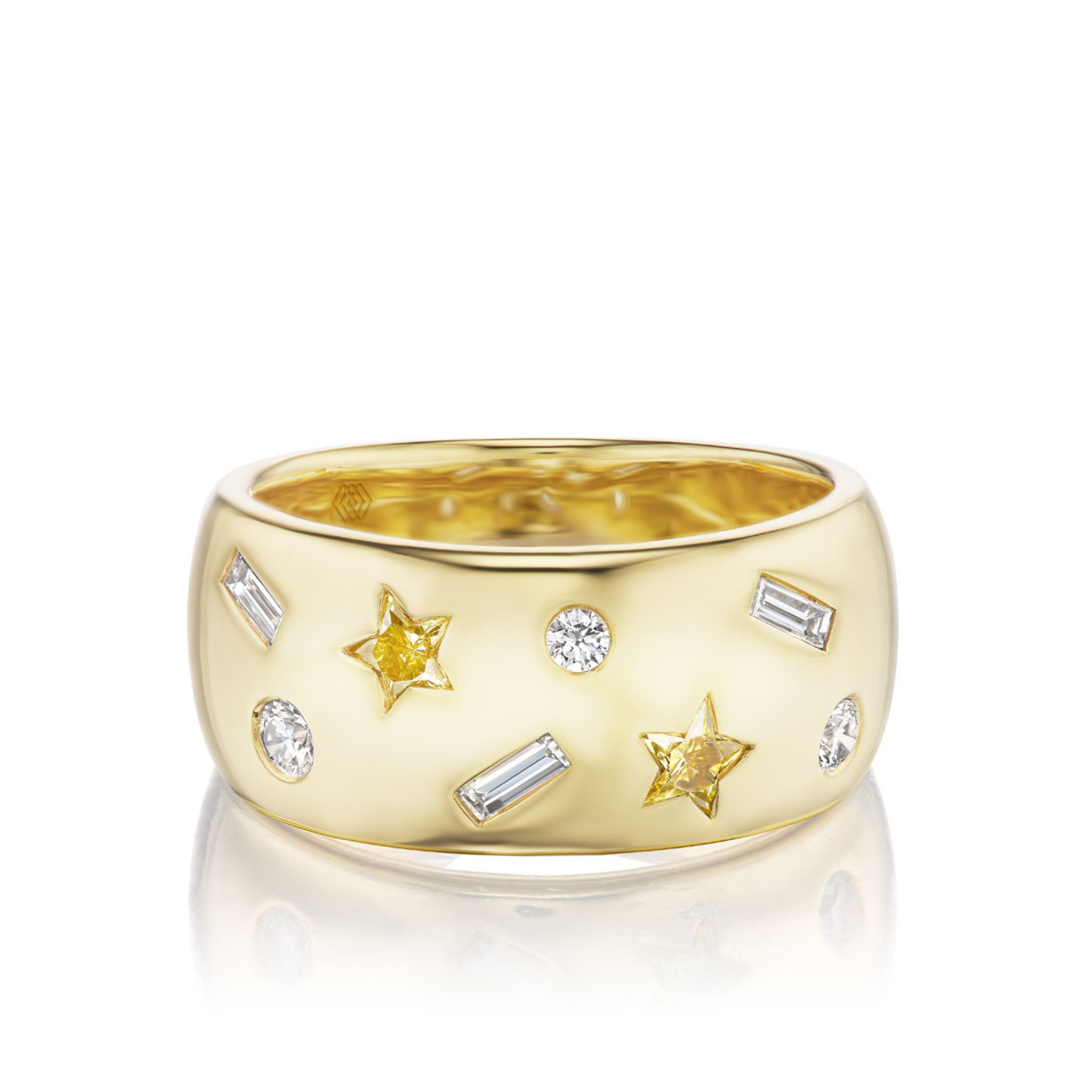 The Yellow Diamond Celestial Cigar Band is a wide 18K yellow gold band with scattered yellow star diamonds, round white diamonds, and baguette-cut diamonds.