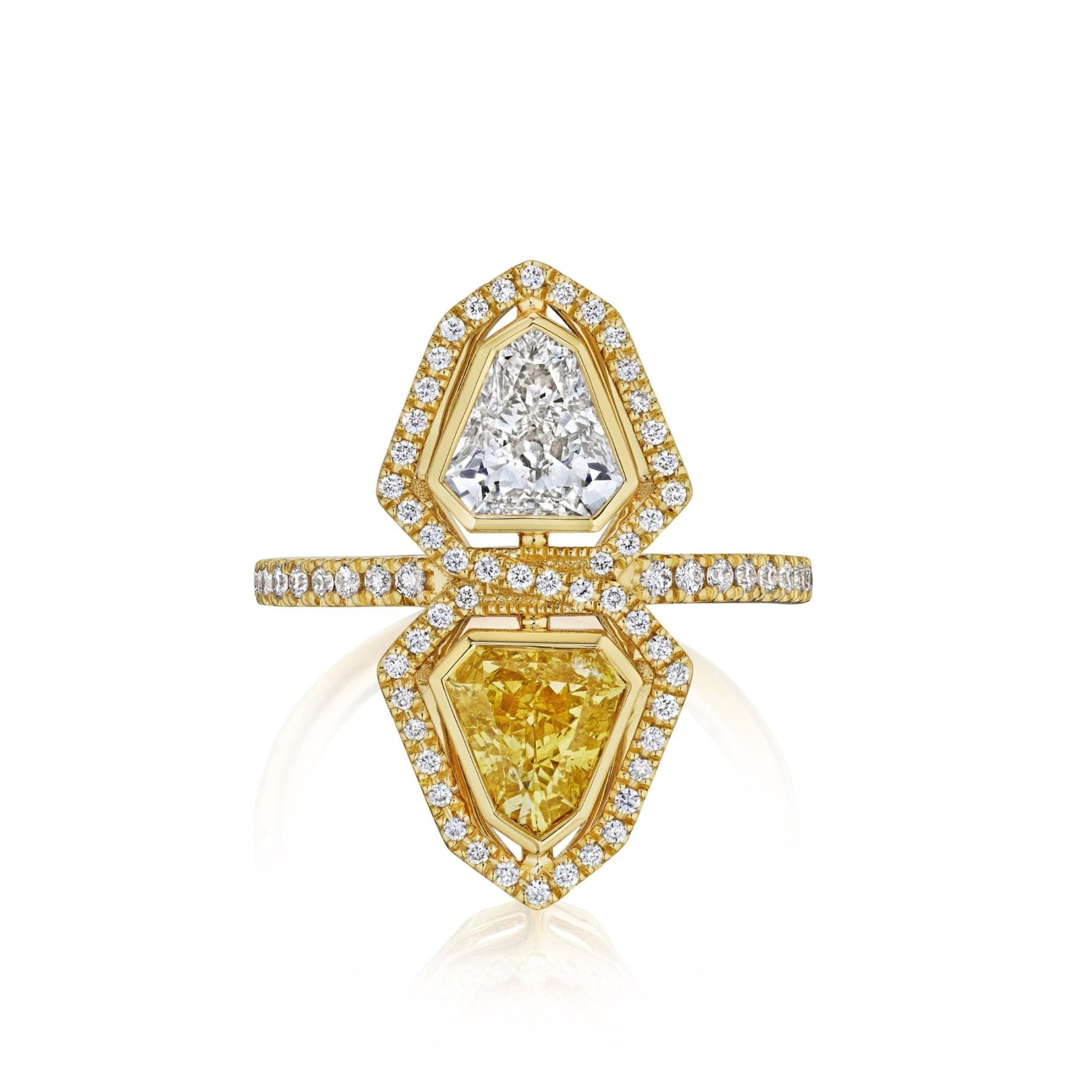 The Yellow Diamond and White Diamond Double Shield Ring with Halo in Yellow Gold features a split-shank band with one white diamond, one yellow diamond, both haloed by small round diamonds, and a bold geometric mirrored shield design.