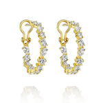 Mixed Shape Diamond Hoops in 18K lever back style feature alternating round, oval, and rectangular diamonds. Shown on a white background with subtle reflections below each earring.