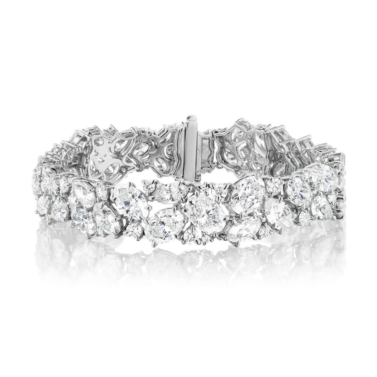 The Cluster Diamond Evening Bracelet showcases sparkling diamond clusters set in an 18k white gold band, beautifully displayed against a white background.