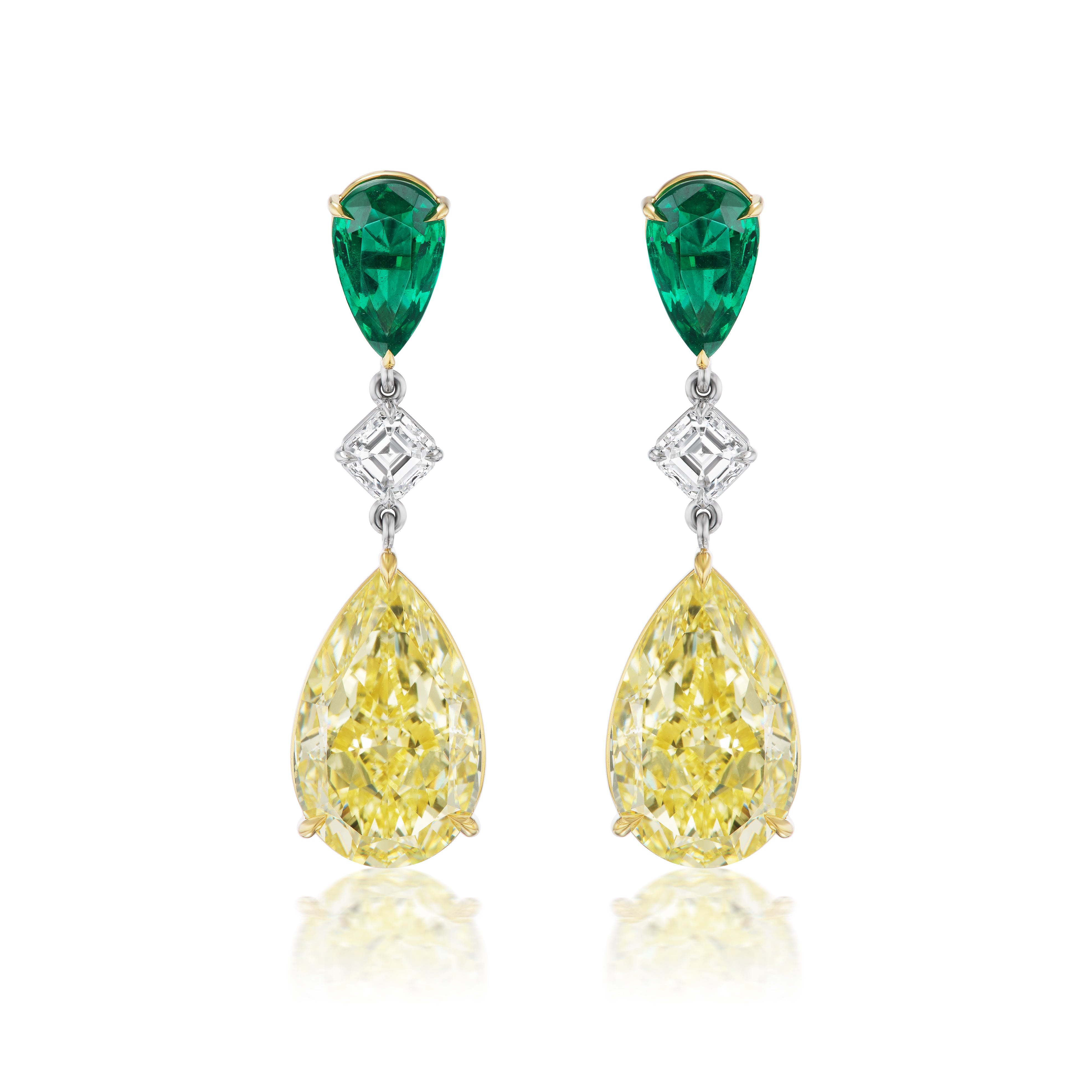 Drop Earrings in yellow gold feature pear shape emeralds at the top, Asscher cut diamonds in the middle, and large fancy yellow diamonds dangling at the bottom.