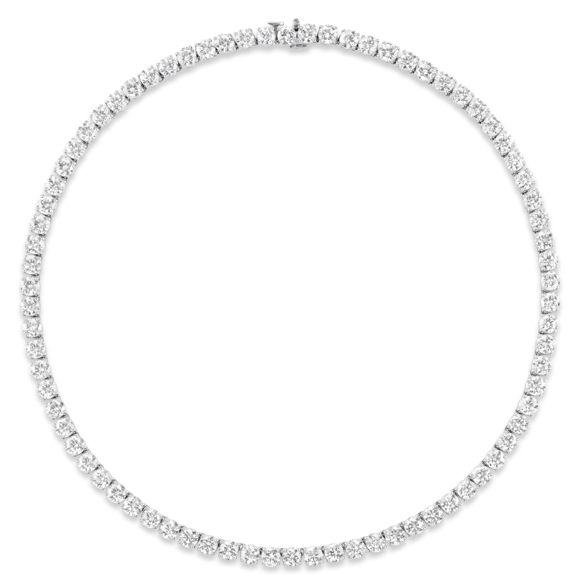 The Large Round Diamond Tennis Necklace showcases a continuous row of round diamonds set in 18K gold and is secured by a slim chain with a clasp at the back.