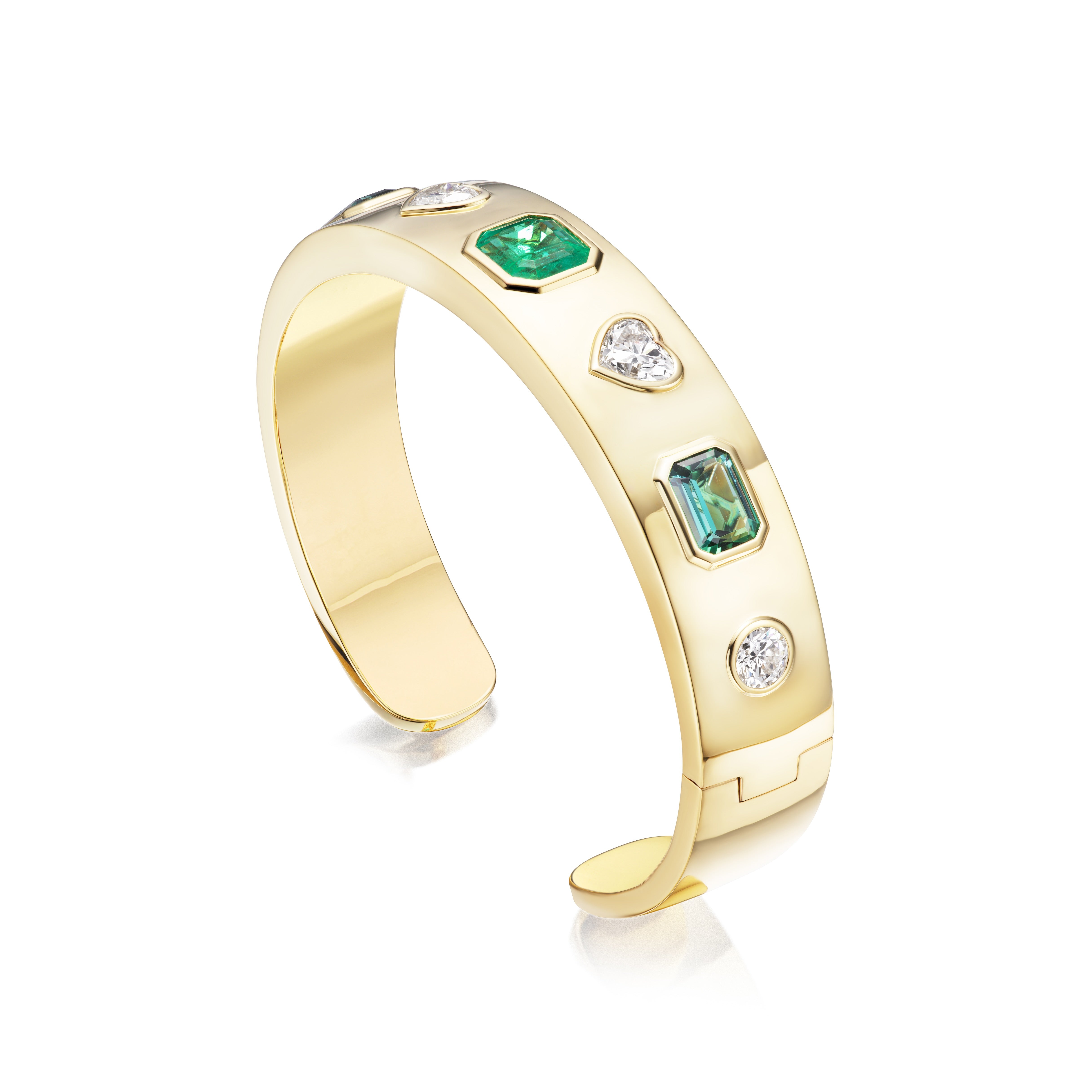 The Bezel Set Mixed Shape Diamond and Emerald Bangle in Yellow Gold showcases emeralds and diamonds in various shapes set in polished 18K yellow gold against a white background.