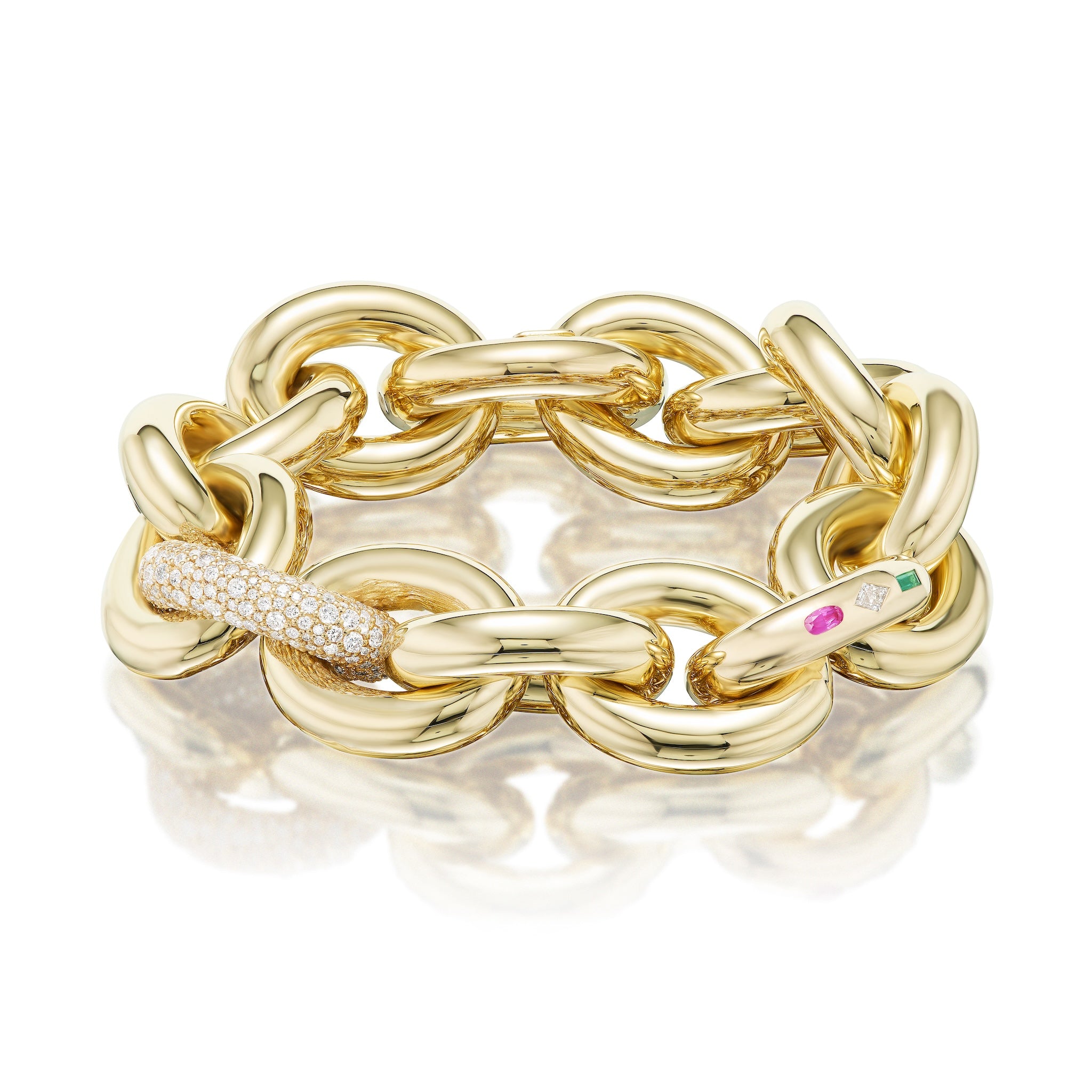 The Chunky Link Bracelet in yellow gold features large interlocking links, with pavé diamonds and burnish-set sapphire, diamond, and emerald accents.