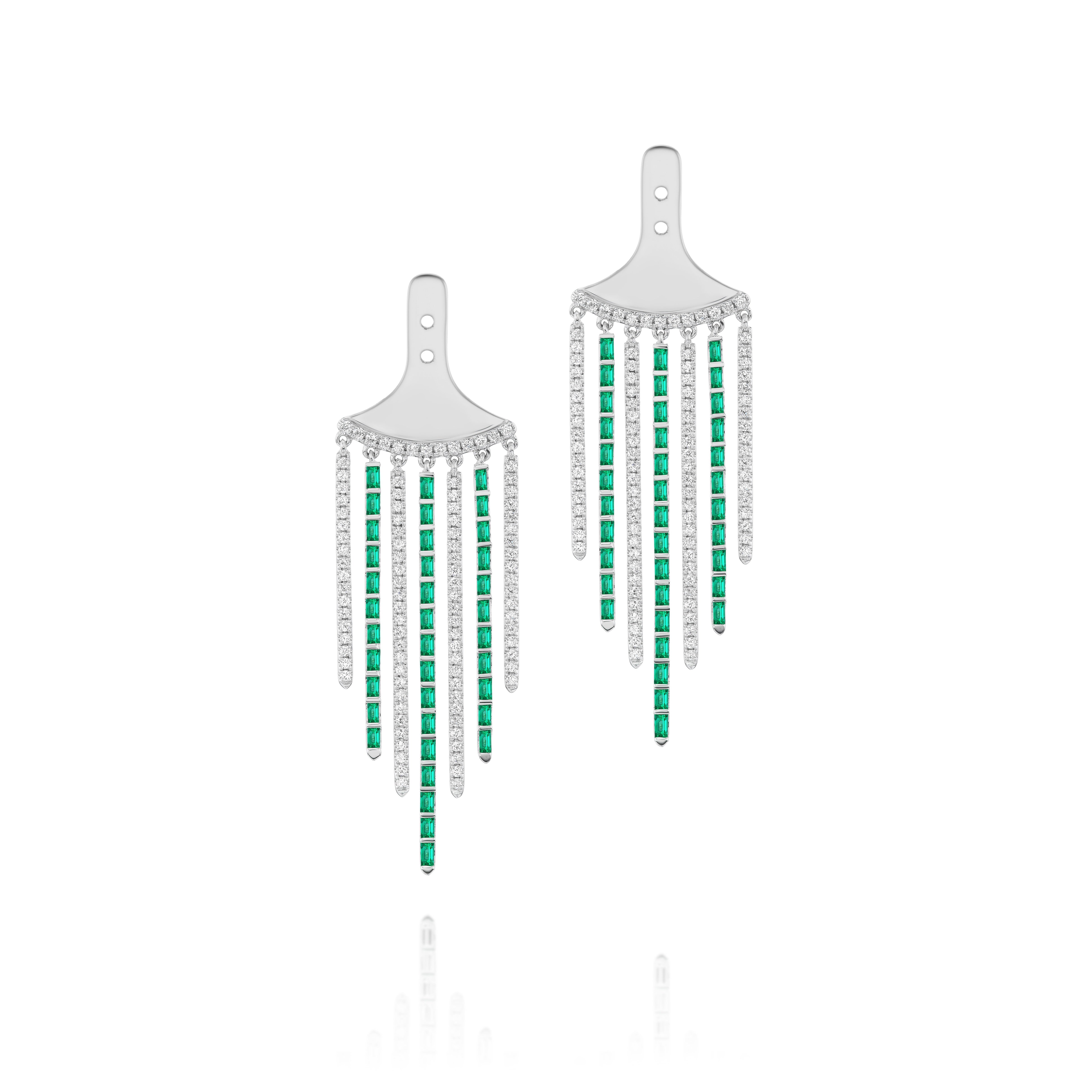 The Raining Diamond and Emerald Ear Jackets in White gold are silver chandelier earrings with five dangling strands, each adorned with alternating baguette emeralds and round diamonds, shown on a white background.