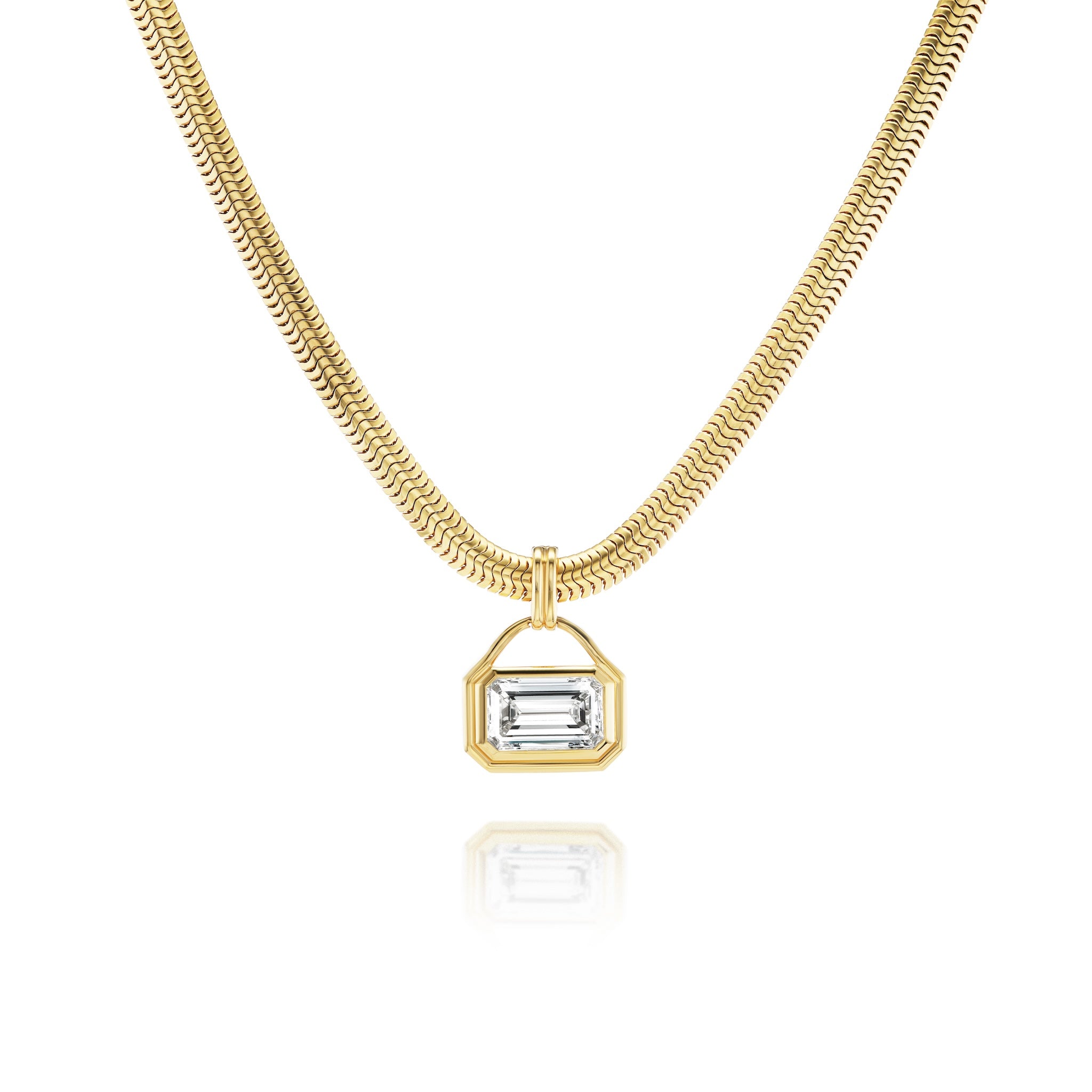 East-West Bezel Set Emerald Cut Diamond Pendant Necklace in Yellow Gold shown on a white background, featuring a rectangular emerald-cut diamond set in a gold bezel with a subtle reflection below.