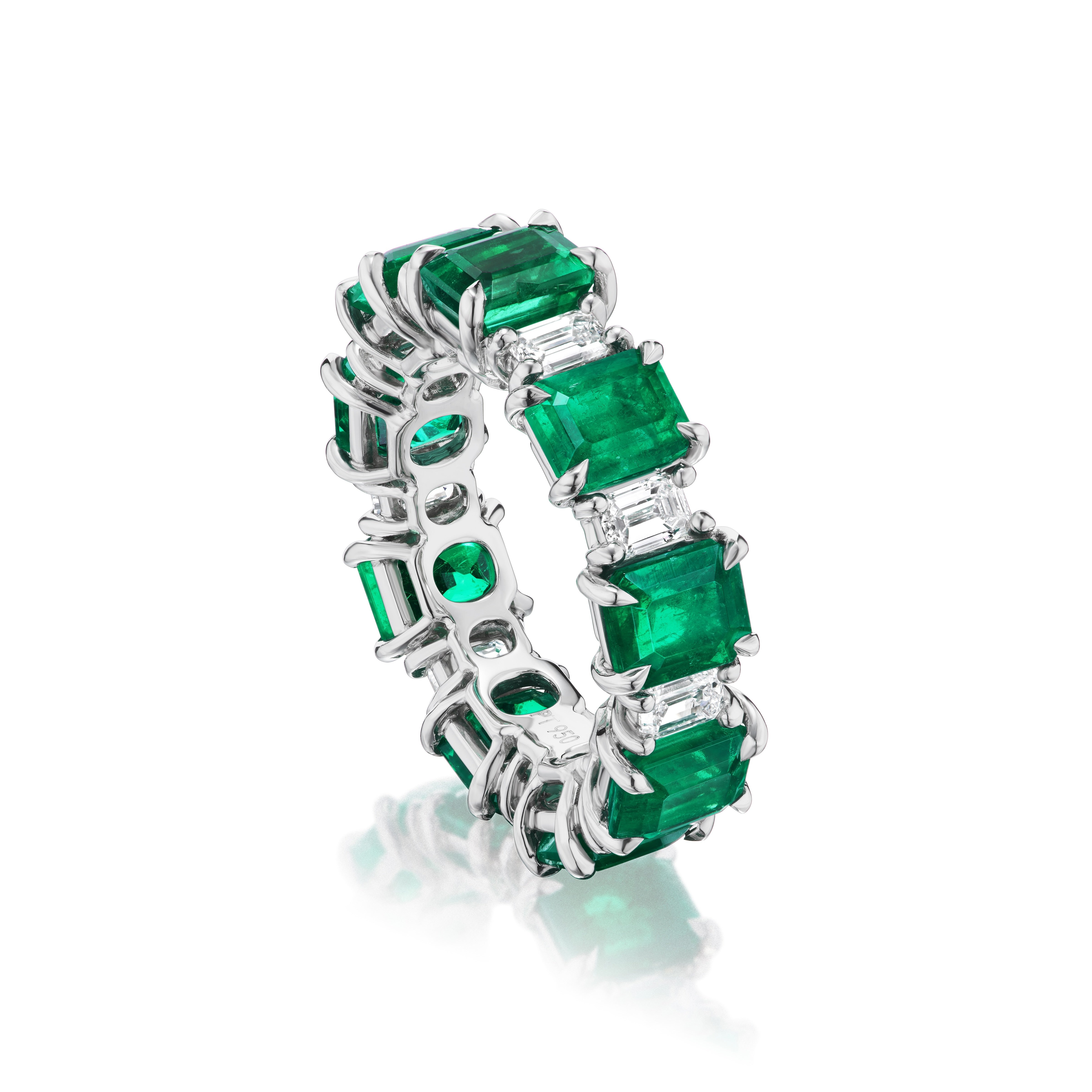 The Alternating Emerald Cut Diamond and Emerald Eternity Band features emeralds and diamonds set in 18k white gold—a striking, modern twist on the classic engagement ring.