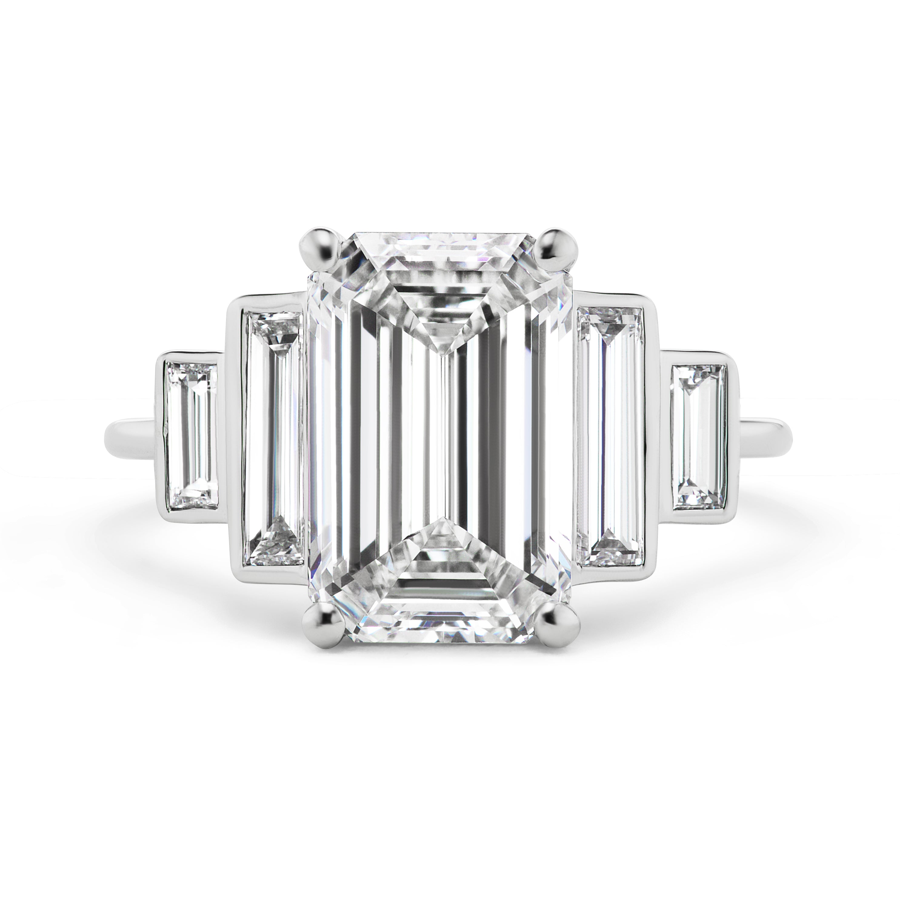 The Echo Emerald Cut Diamond Engagement Ring showcases a modern, minimalist 18K white gold design with a central emerald cut diamond and bezel set baguette side stones for elegant symmetry.