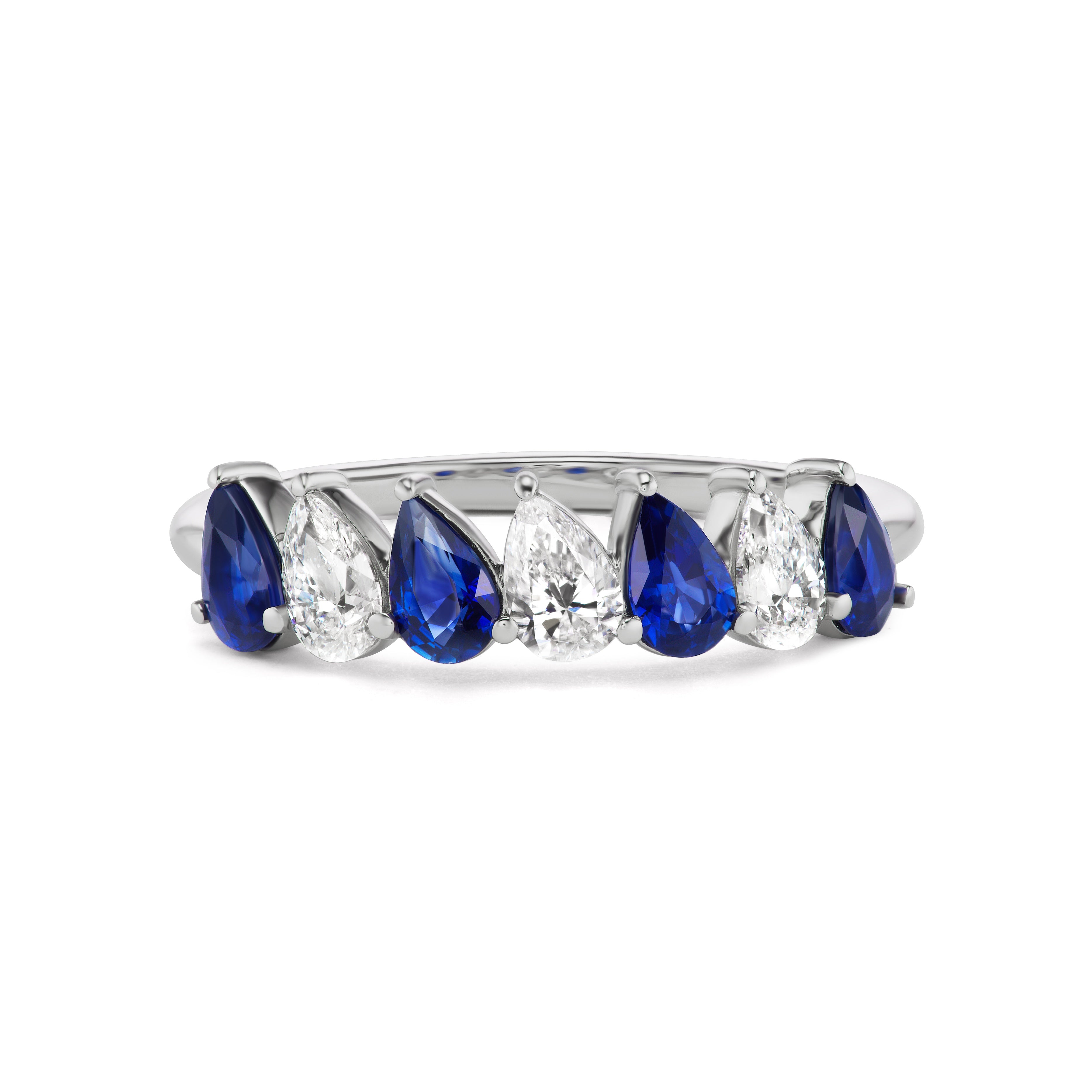 The Diagonal Pear Eternity Band features alternating pear-shaped blue sapphires and white diamonds set in 18K white gold—a striking choice for an elegant bridal band.