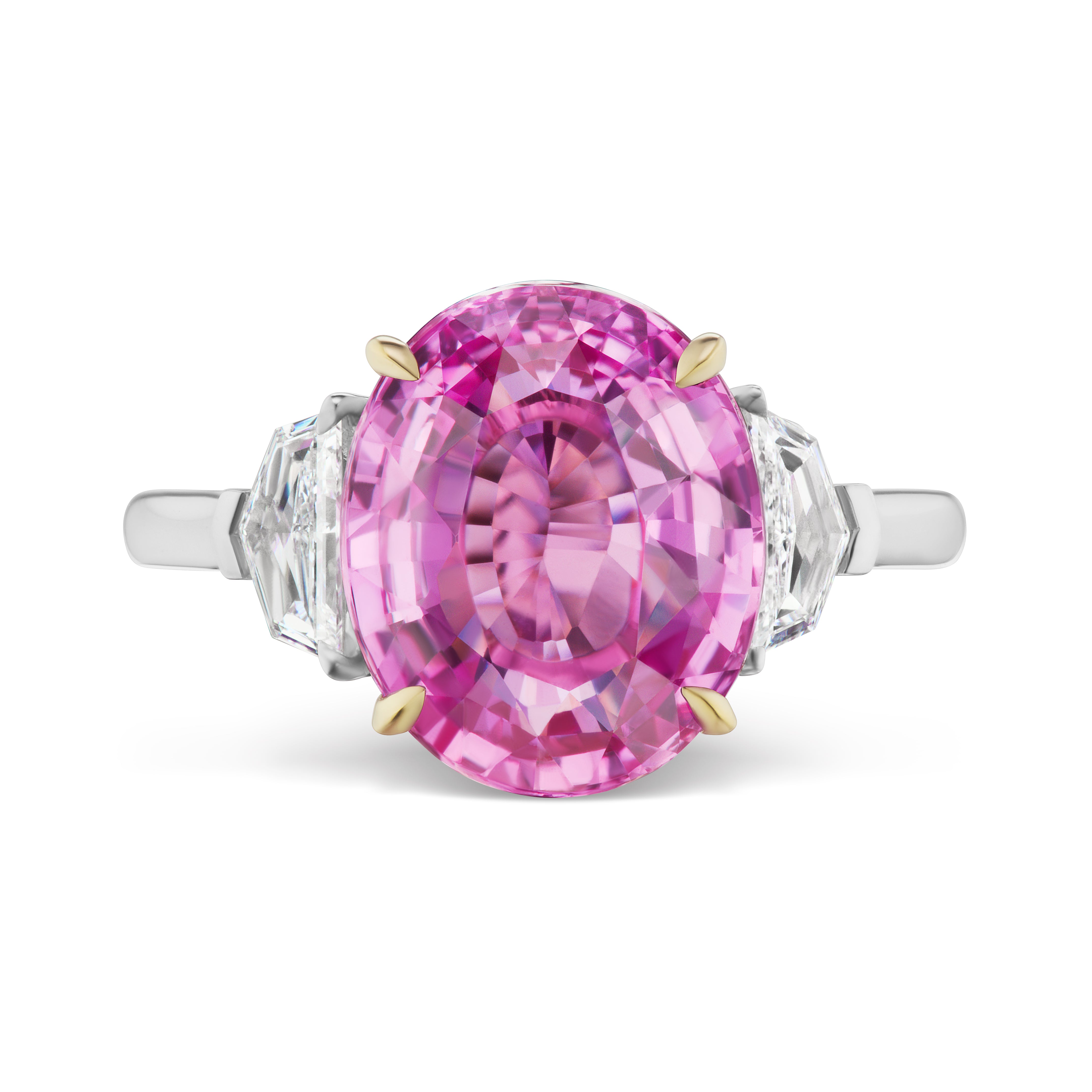 The Oval Sapphire Engagement Ring features an oval-cut pink sapphire center in 18K white gold, set with four prongs and accented by epaulette diamond side stones.