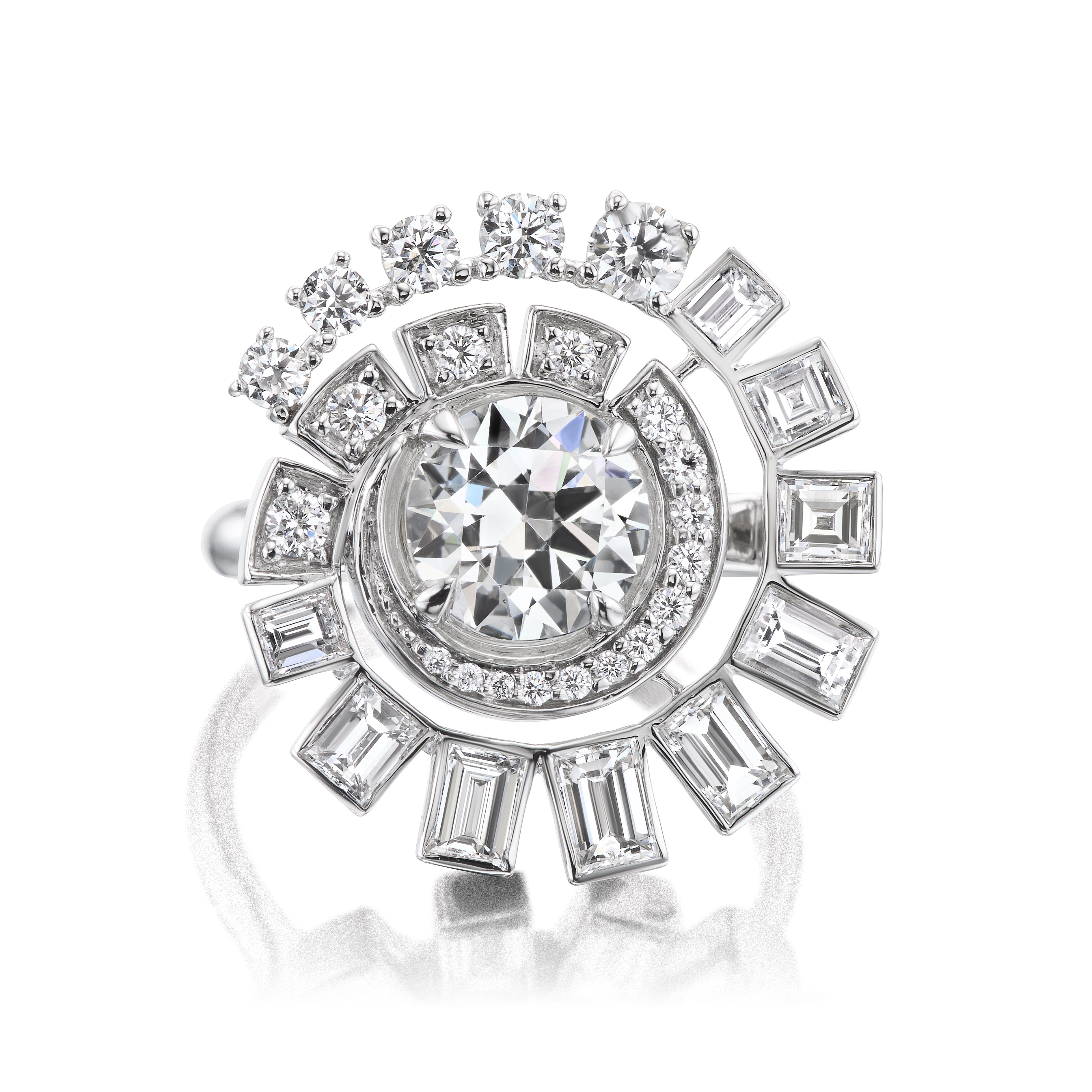 The Spiral Ring in White Gold features a large round diamond at the center, surrounded by concentric circles of Round Brilliant and Baguette Diamonds in an intricate geometric design.