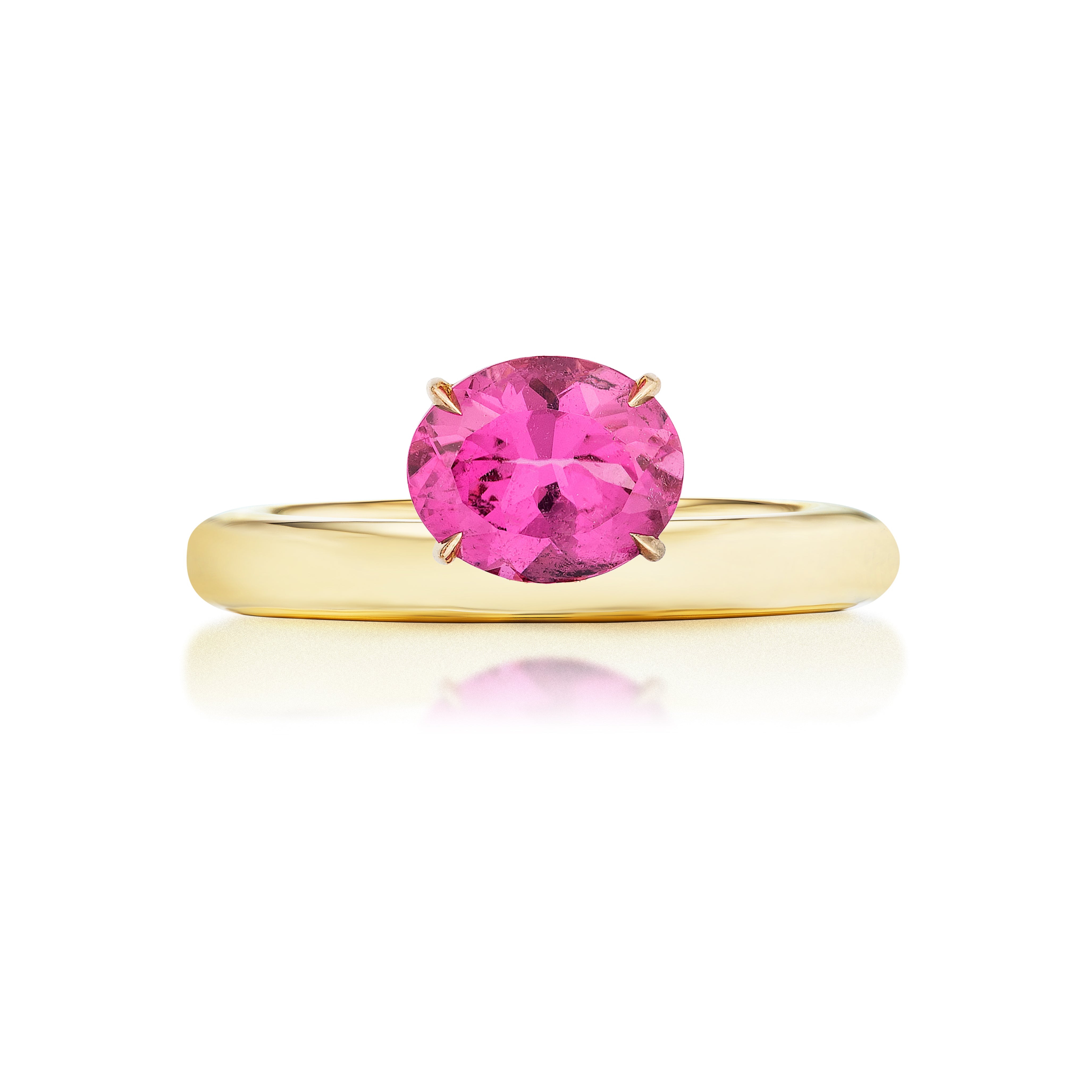 The East-West Set Pinky Ring features an oval pink sapphire in a simple 18K yellow gold setting, displayed against a white background.