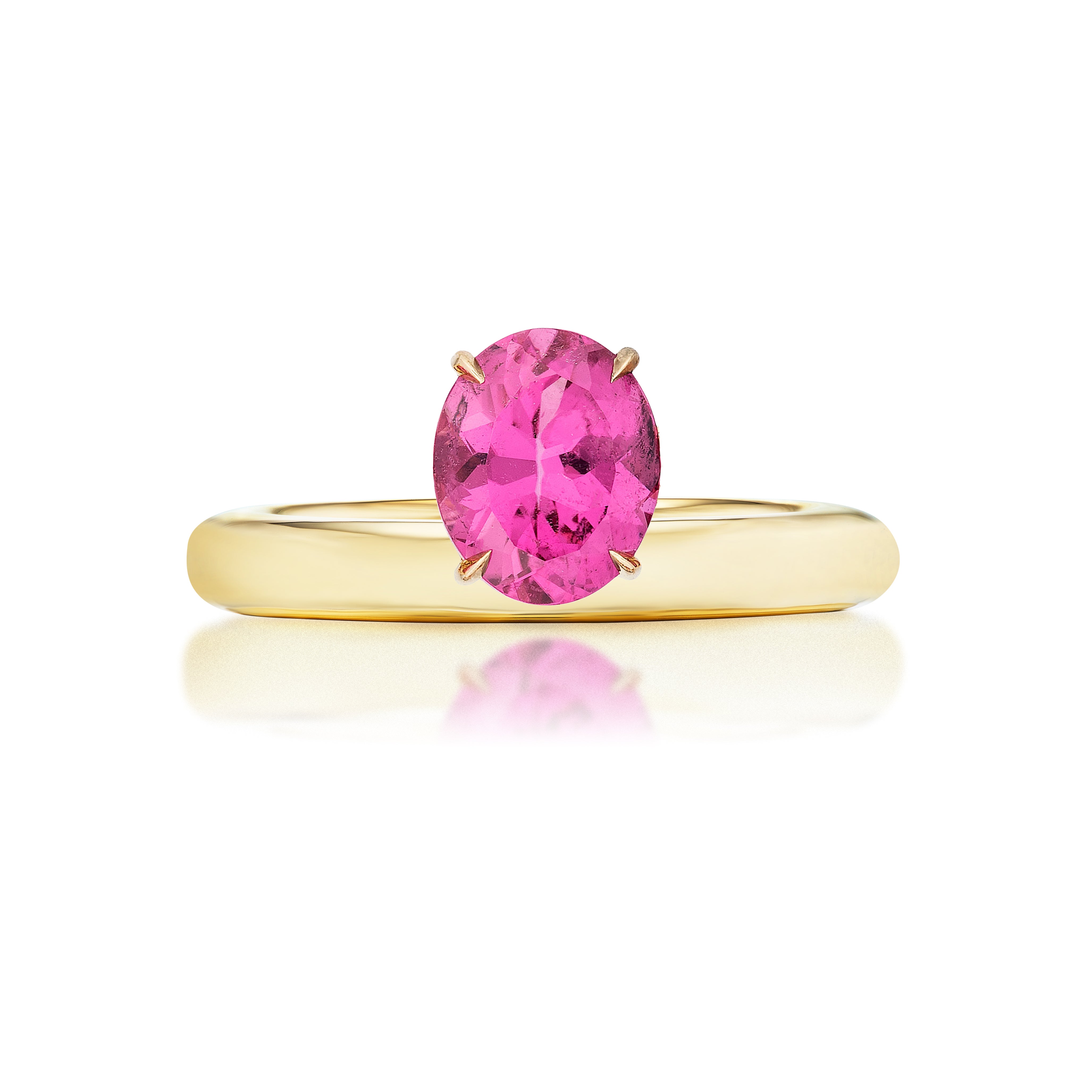 The North-South Set Pinky Ring features an oval pink sapphire in a four-prong 18K yellow gold setting, showcased on a white background with its reflection visible below.