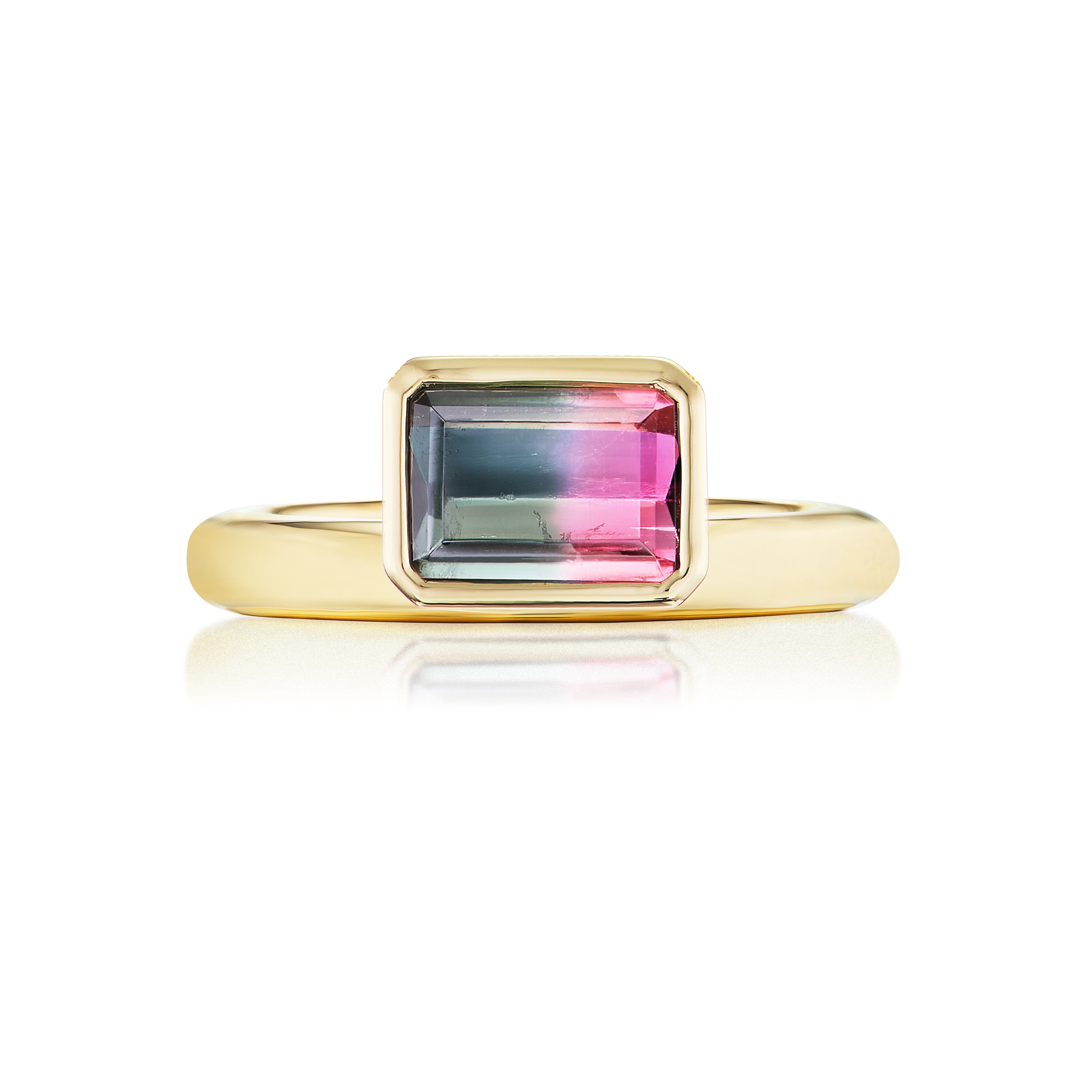 The Pinky Ring in Yellow Gold features an emerald-cut watermelon tourmaline displaying a green, pink, and clear gradient, set on a simple 18K yellow gold band.