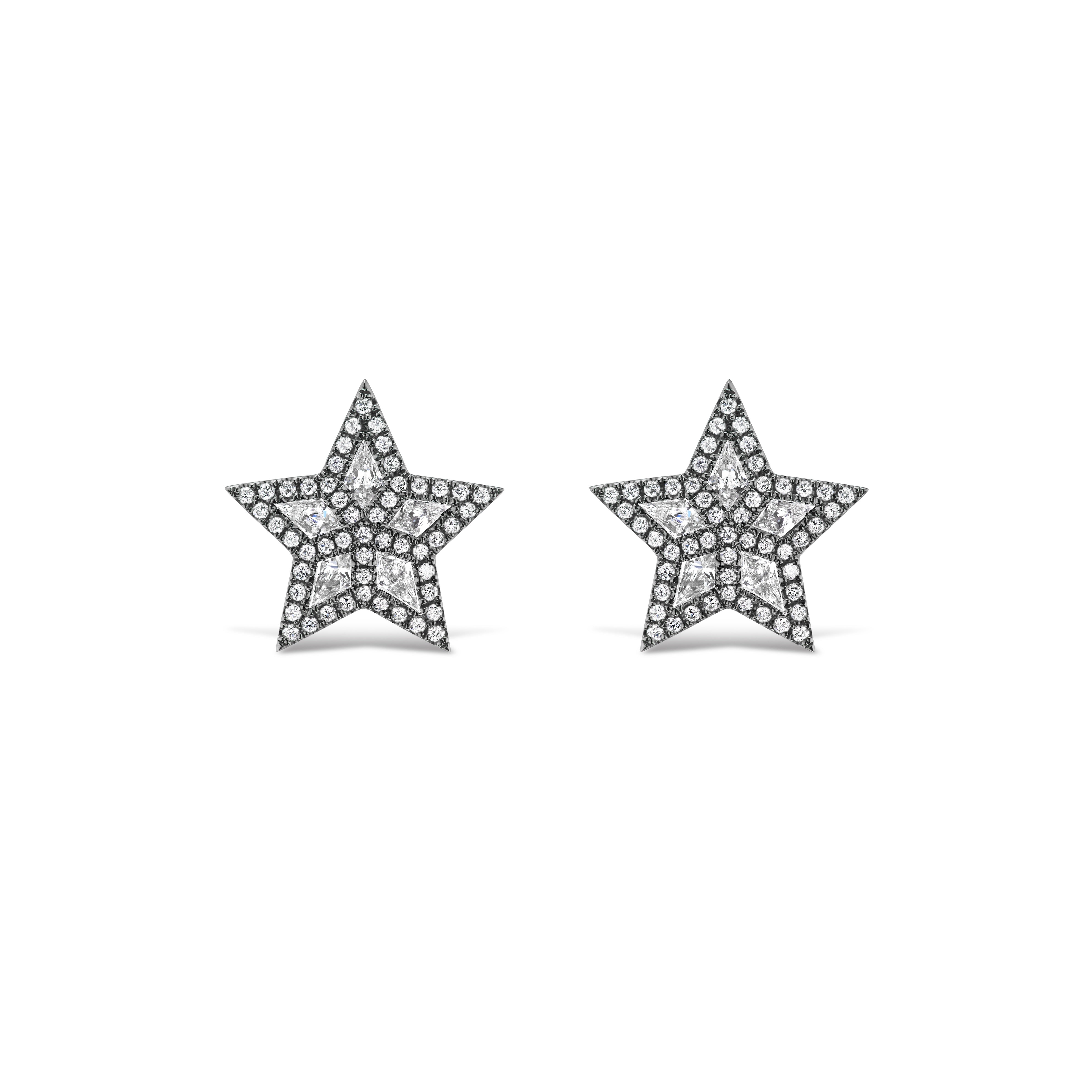 The Pavé Star Studs feature star-shaped designs in black rhodium, each adorned with multiple sparkling kite diamonds. Displayed on a plain white background, these elegant stud earrings offer a distinctive, radiant look.