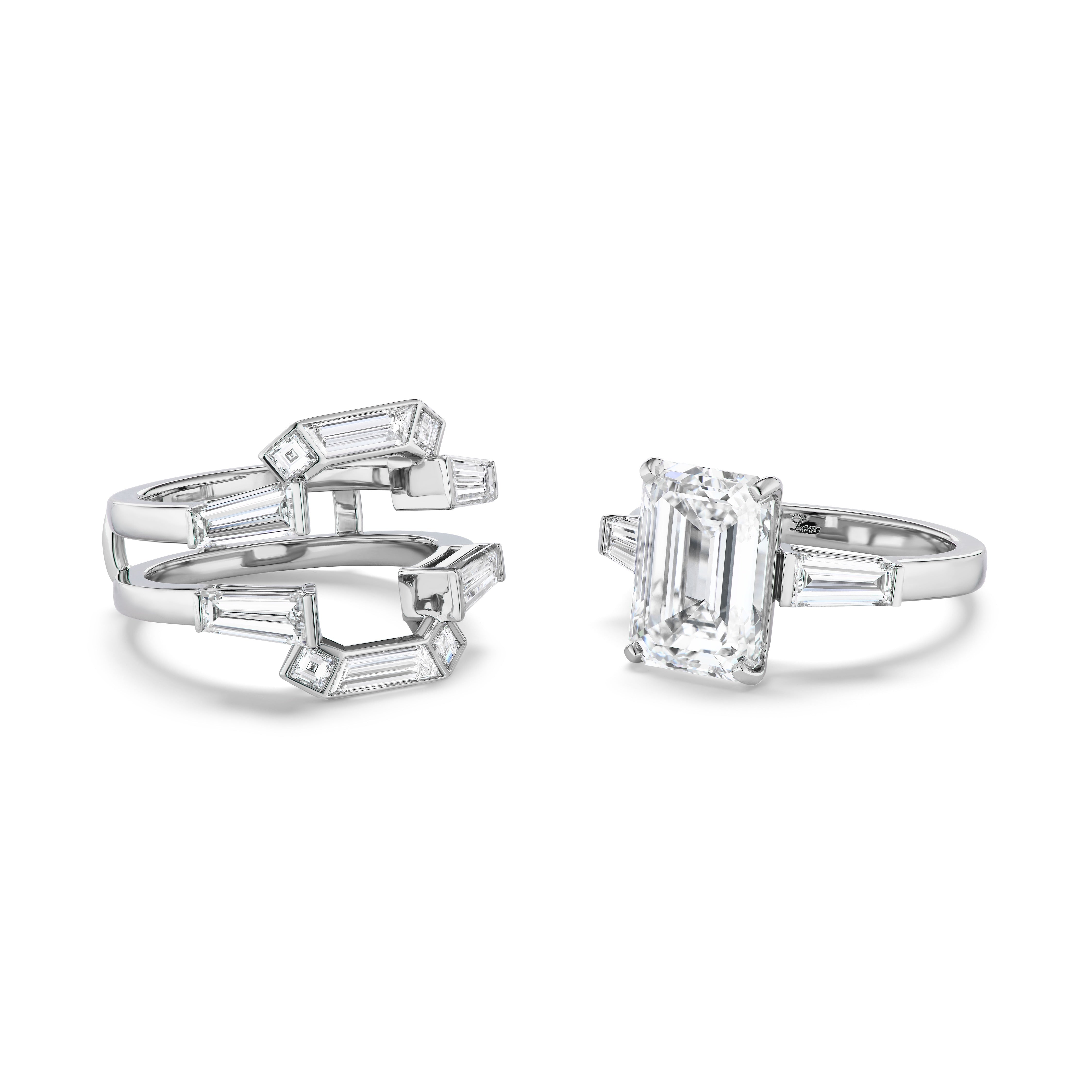 A Bespoke Geometric Bezel Set Baguette and Asscher Cut Diamond Ring Jacket in white gold is displayed on a white background, featuring an open design with baguette and octagon-shaped stones along the band.