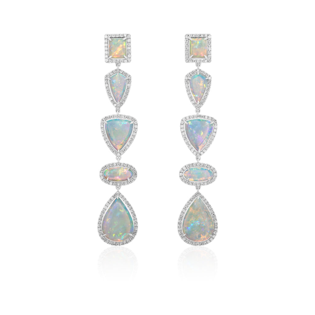 The Opal Chandelier Earrings showcase multiple iridescent opals in various shapes, each framed by sparkling diamonds and set in 18K white gold. Displayed against a white background.