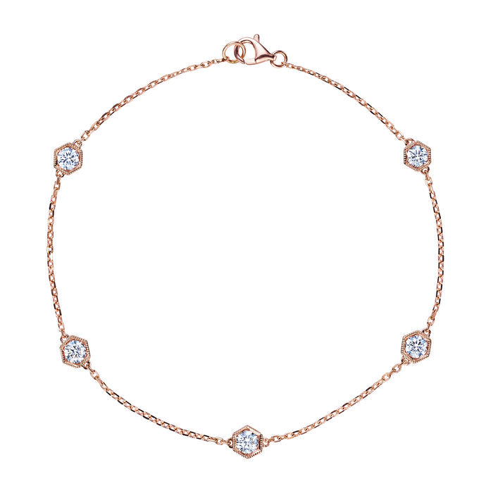 The Serpentine Station Bracelet features five hexagon bezel set diamonds in 18K gold, elegantly spaced along the chain and finished with a small clasp closure.