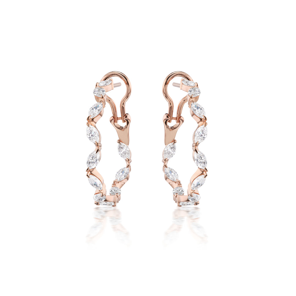 Climbing Ivy Hoops in Rose Gold with marquise diamonds and clear gemstones, showcasing a twisted hoop design, are displayed upright against a white background with a subtle reflection below.