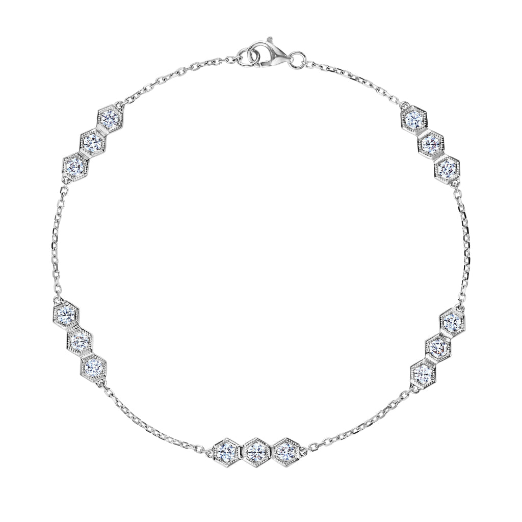 The Serpentine Station Bracelet features trio hexagon bezel-set diamonds spaced along a fine chain and is secured with a lobster clasp.