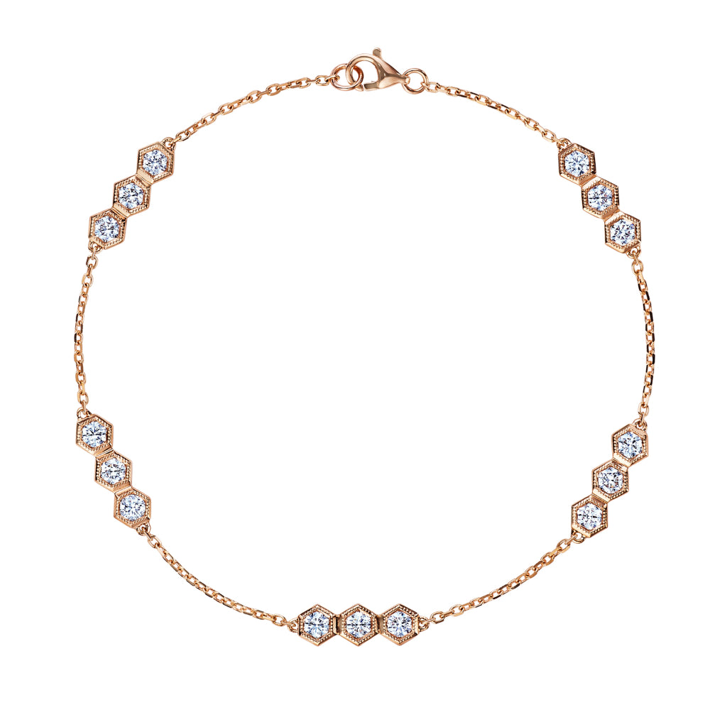 The Serpentine Station Bracelet features trio hexagon bezel-set diamonds spaced along a delicate chain, crafted in 18K gold and secured with a lobster clasp.
