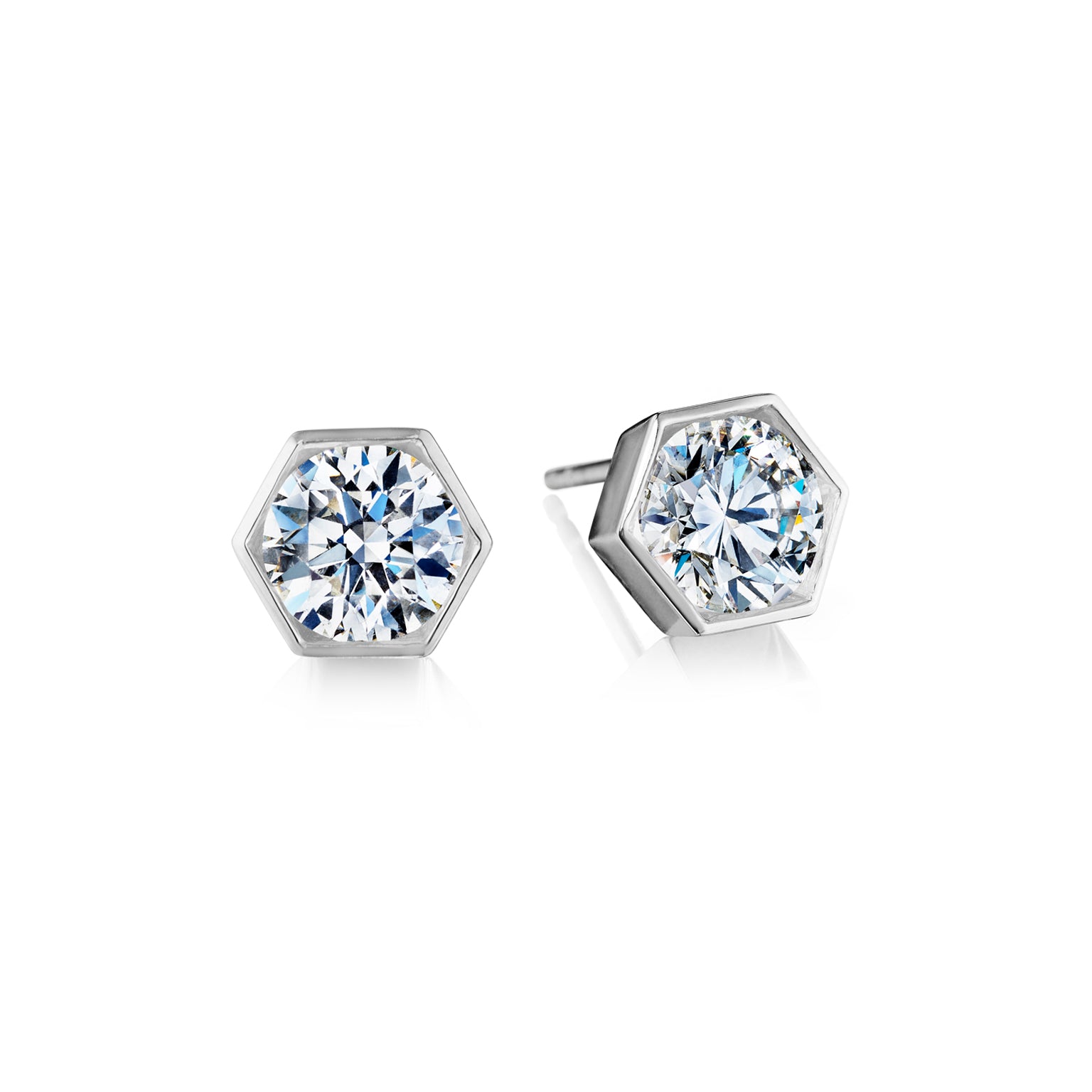 Hexagon Bezel Set Diamond Studs in White Gold featuring sparkling round diamonds bezel set in 18K white gold, shown against a white background.