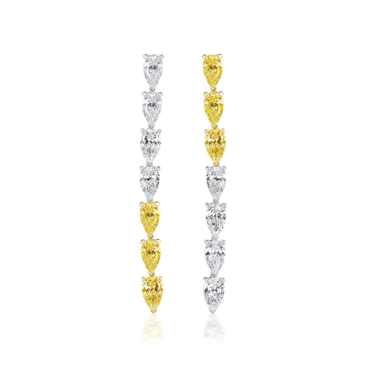 This & That Chasing Pears Drop Earrings, crafted in white and yellow gold with pear diamonds, feature alternating white and yellow stones; the left starts with white, the right with a vibrant yellow diamond on a clean white background.