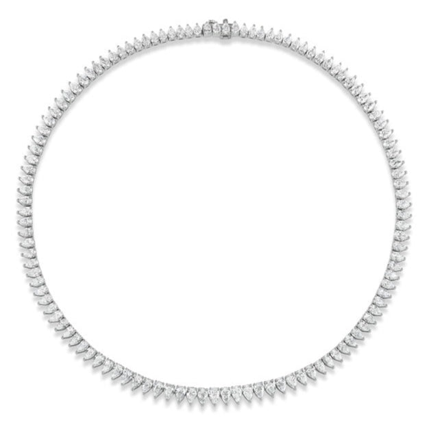 The Pear Diamond Tennis Necklace in White Gold showcases teardrop-shaped diamonds bordered by small round diamonds, set in 18k white gold for an elegant and symmetrical look.