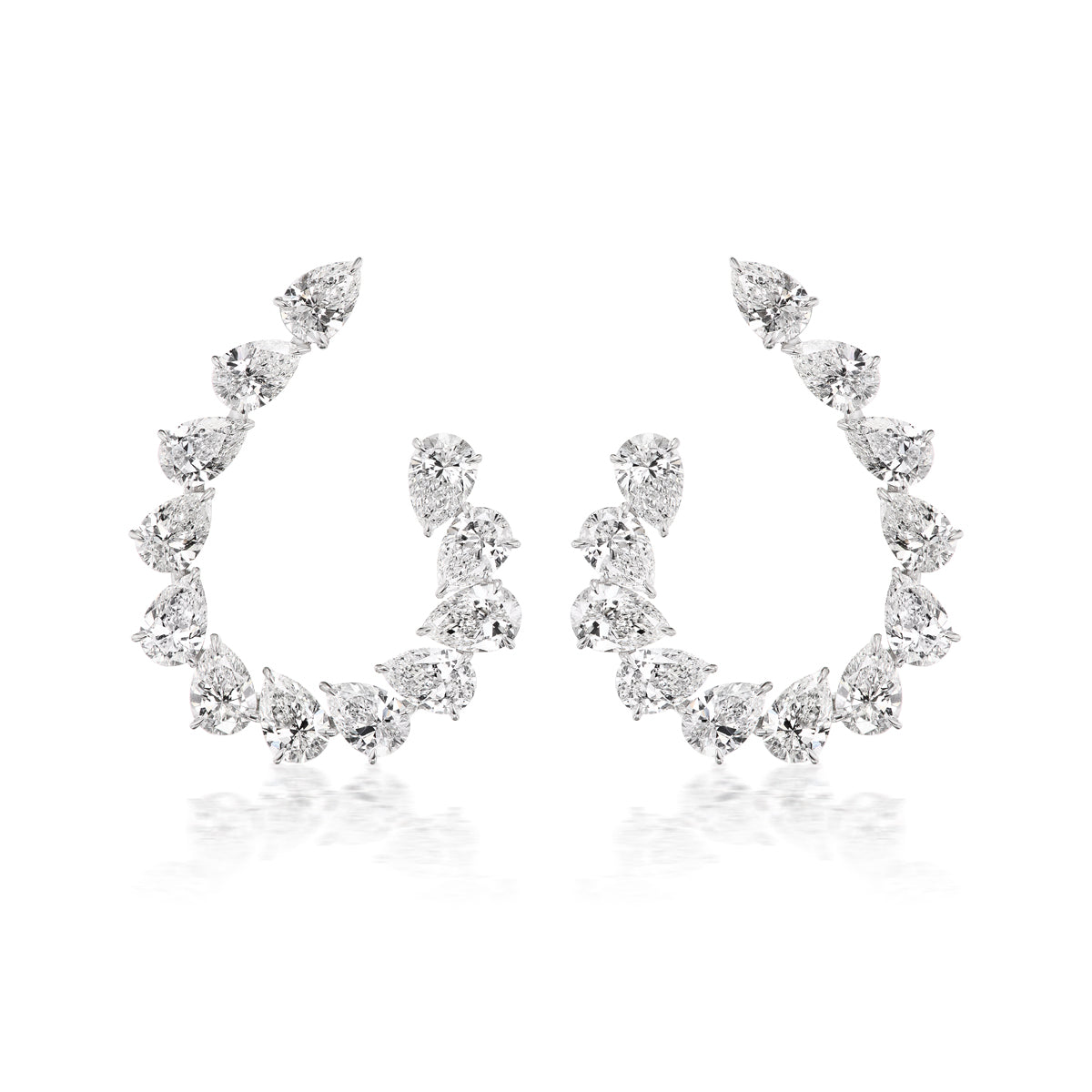 The Teardrop Front-to-Back Earrings feature sparkling pear-shaped white gemstones elegantly arranged along curved hoops, evoking the look of teardrop diamond earrings, and are displayed on a white background.