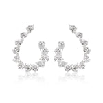 The Teardrop Front-to-Back Earrings feature sparkling pear-shaped white gemstones elegantly arranged along curved hoops, evoking the look of teardrop diamond earrings, and are displayed on a white background.
