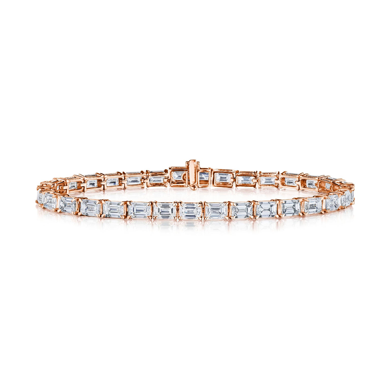 The East-West Emerald Cut Tennis Bracelet showcases a single row of emerald cut diamonds in rose gold, set side by side with a secure central clasp.