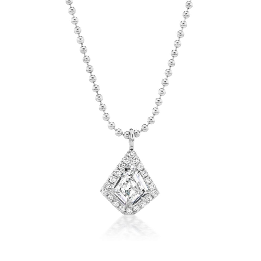 The Pavé Kite Diamond Solitaire Pendant in White Gold features a silver beaded chain with a kite-shaped diamond pavé pendant, showcasing a central clear gemstone bordered by smaller sparkling stones.