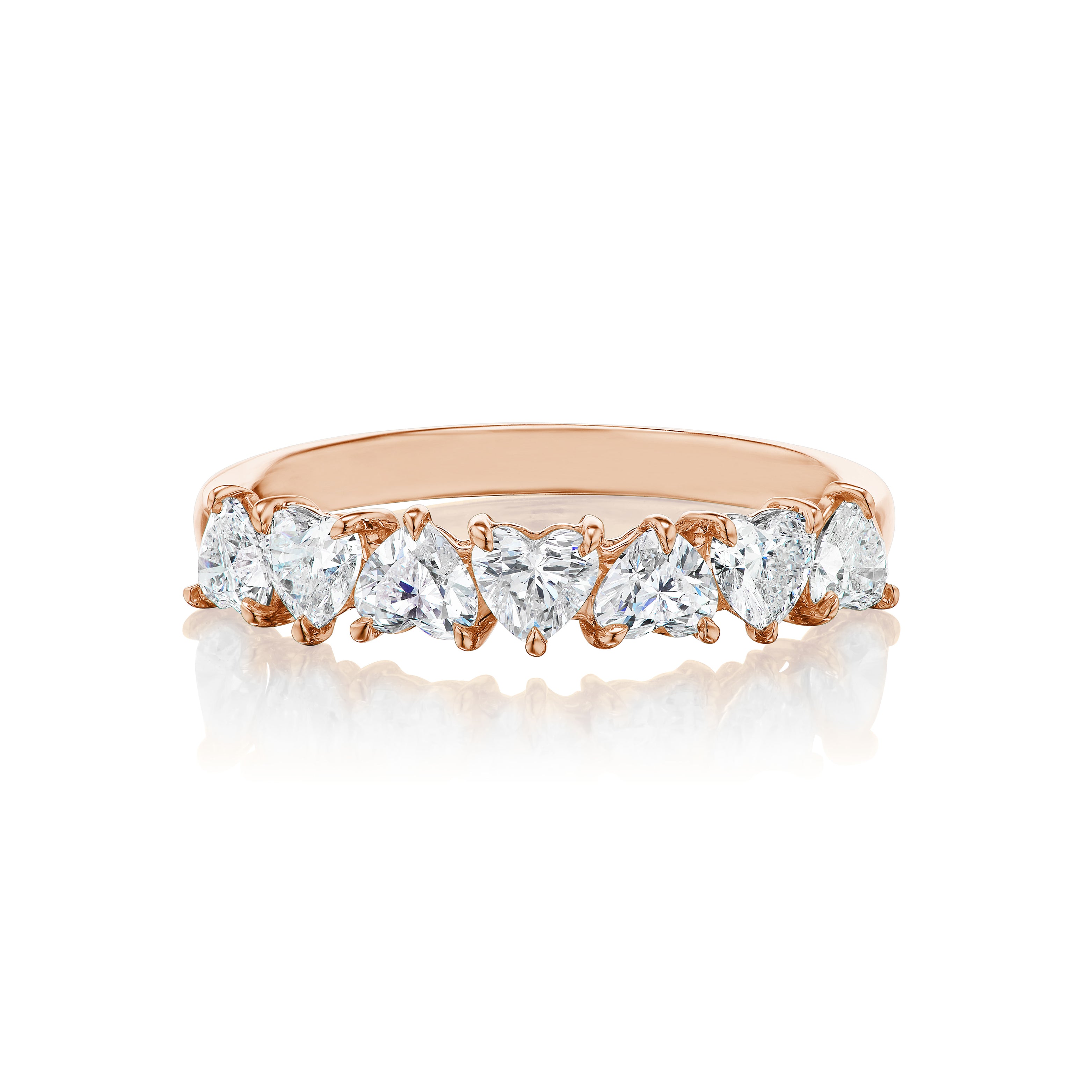 The Up and Down Heart Diamond Half Eternity Band in rose gold showcases seven sparkling heart-shaped diamonds set across the band, displayed on a white background with a soft reflection—ideal for bridal or celebration rings.