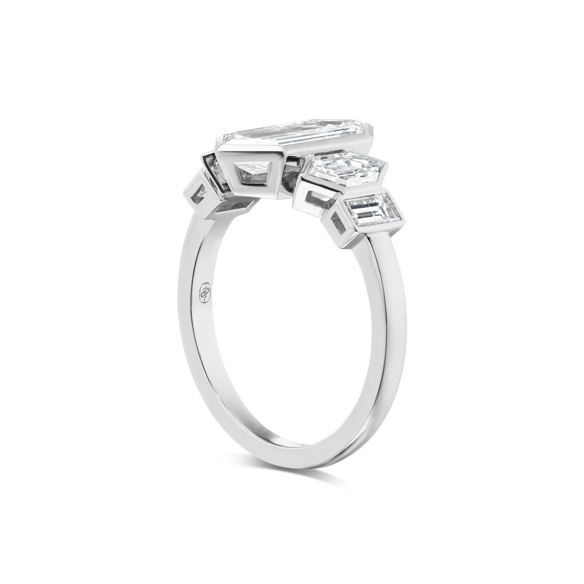 The Elongated Hexagon Diamond Engagement Ring with Hexagon and Baguette Side Stones in white gold is shown from an angled side view, highlighting its geometric settings and array of rectangular, square, and hexagonal diamonds.