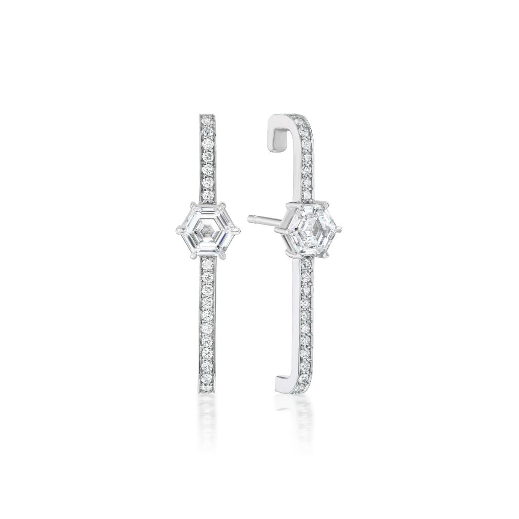 The Hexagon Diamond Pavé Ear Cuffs are modern 18K white gold earrings, featuring a vertical row of small round diamonds with a striking hexagon diamond accent at the center, beautifully showcased on a white background.