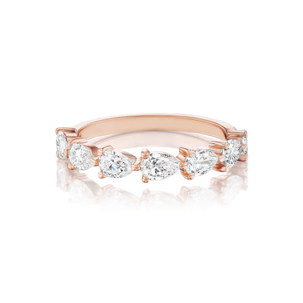 The Chasing Pears Diamond Half Eternity Band in Rose Gold features alternating round and pear-shaped white diamonds, offering a continuous elegant design—ideal for celebration or bridal rings.