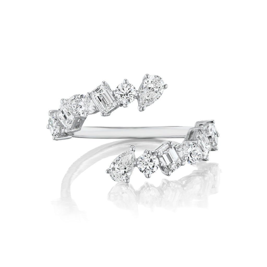 The Wraparound Ring with Mixed Shape Diamonds showcases alternating round, emerald, and pear-shaped diamonds in a silver open design inspired by diamond rings, displayed on a white background.