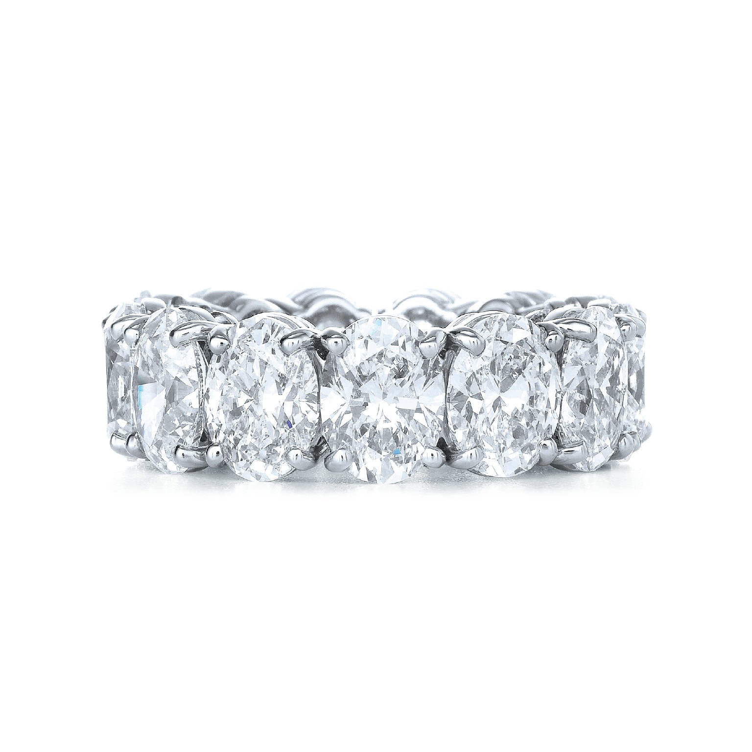 The Oval Diamond Eternity Band features a full circle of large, oval-cut diamonds set in platinum, each held by four prongs for a continuous sparkling design—perfect for bridal or special occasions.
