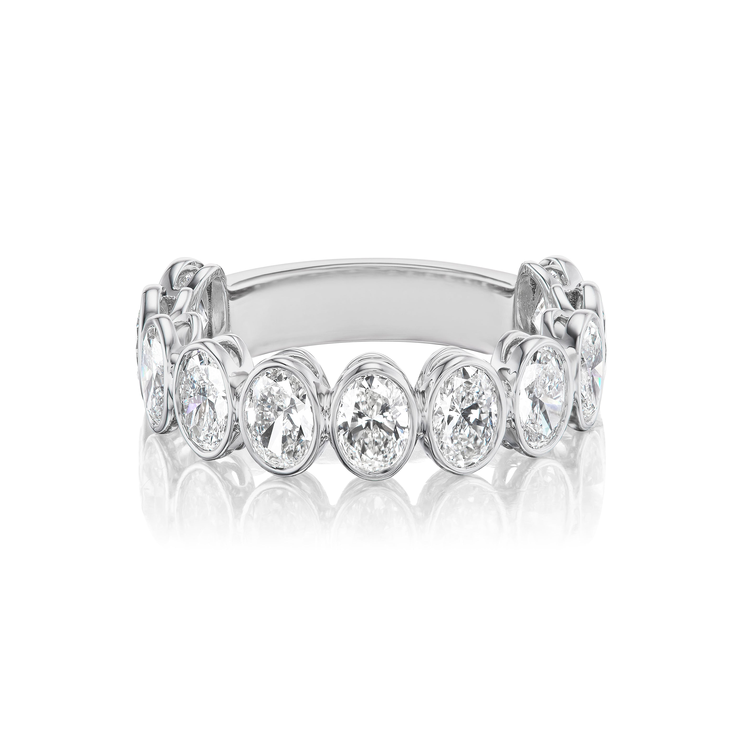 The Oval Bezel Set Diamond Half Eternity Band in white gold showcases a row of round, bezel-set diamonds along the band, displayed on a white background with a subtle reflection.