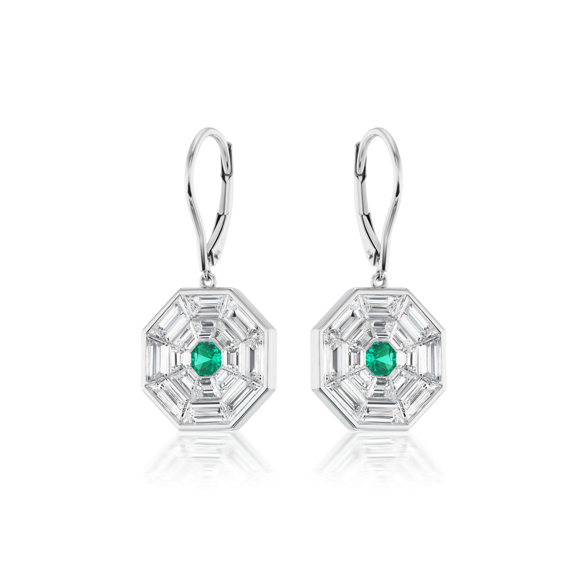 The Emerald and Diamond Mosaic Drop Earrings feature a central green emerald, baguette-cut clear stones, and 18k white gold lever-back hooks, displayed on a white background.