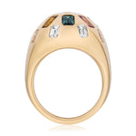 The Confetti Bombé Ring in 18k yellow gold features a rounded dome set with customizable clear, green, yellow, and pink gemstones. Side view highlights its intricate stone settings.
