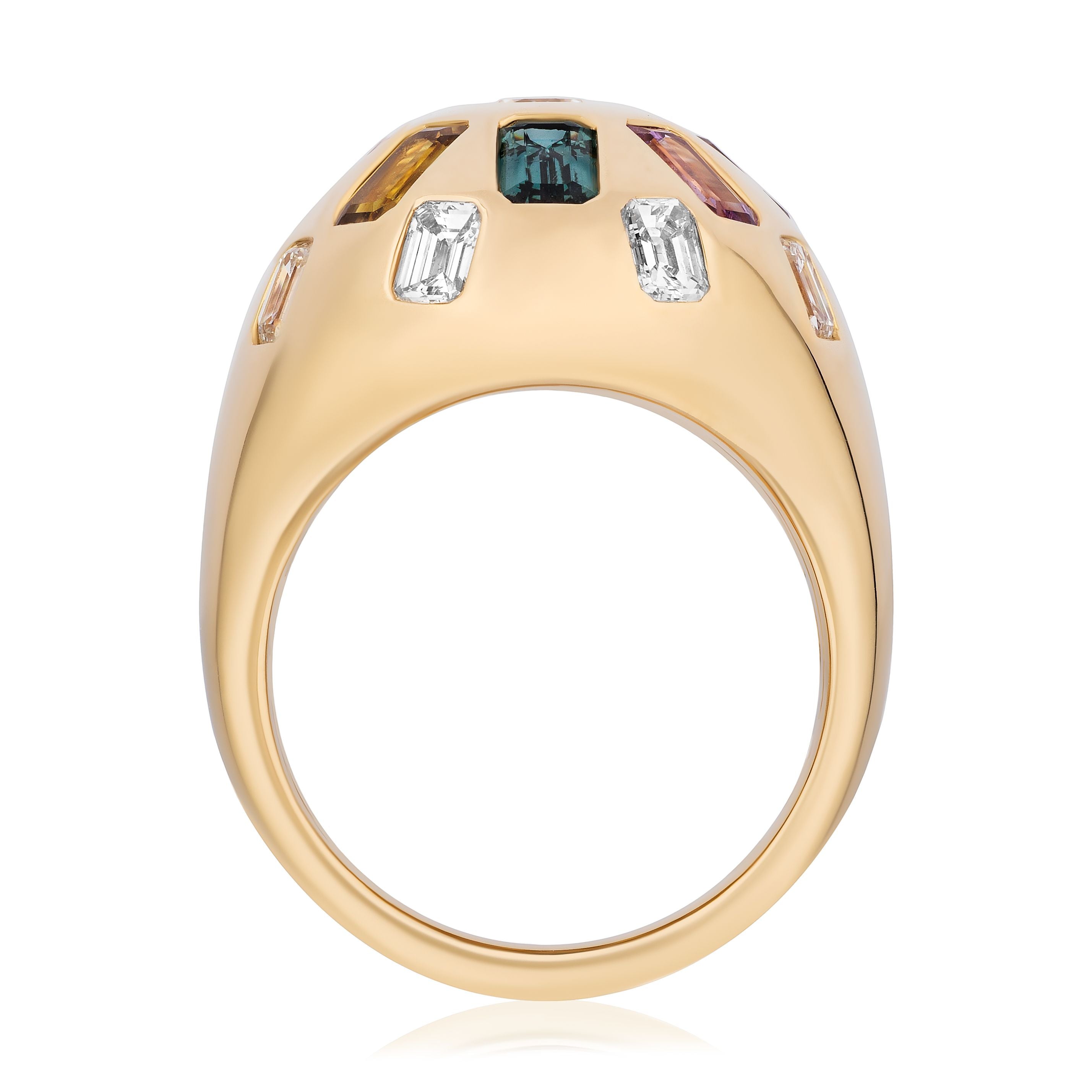 The Confetti Bombé Ring in 18k yellow gold features a rounded dome set with customizable clear, green, yellow, and pink gemstones. Side view highlights its intricate stone settings.