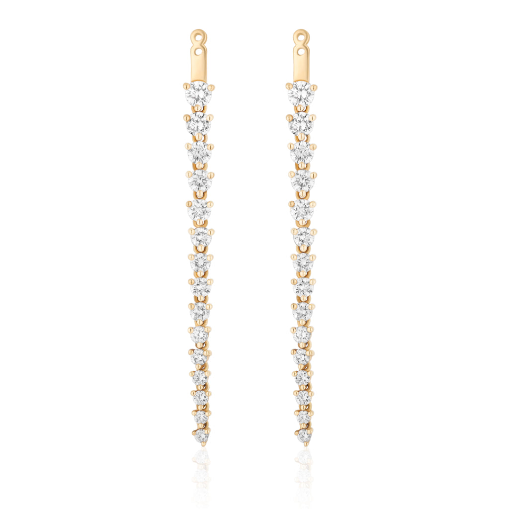 The Graduated Tennis Ear Jackets in Yellow Gold feature round brilliant diamonds arranged vertically, each stone gradually decreasing in size toward the tip for an elegant drop earring design.