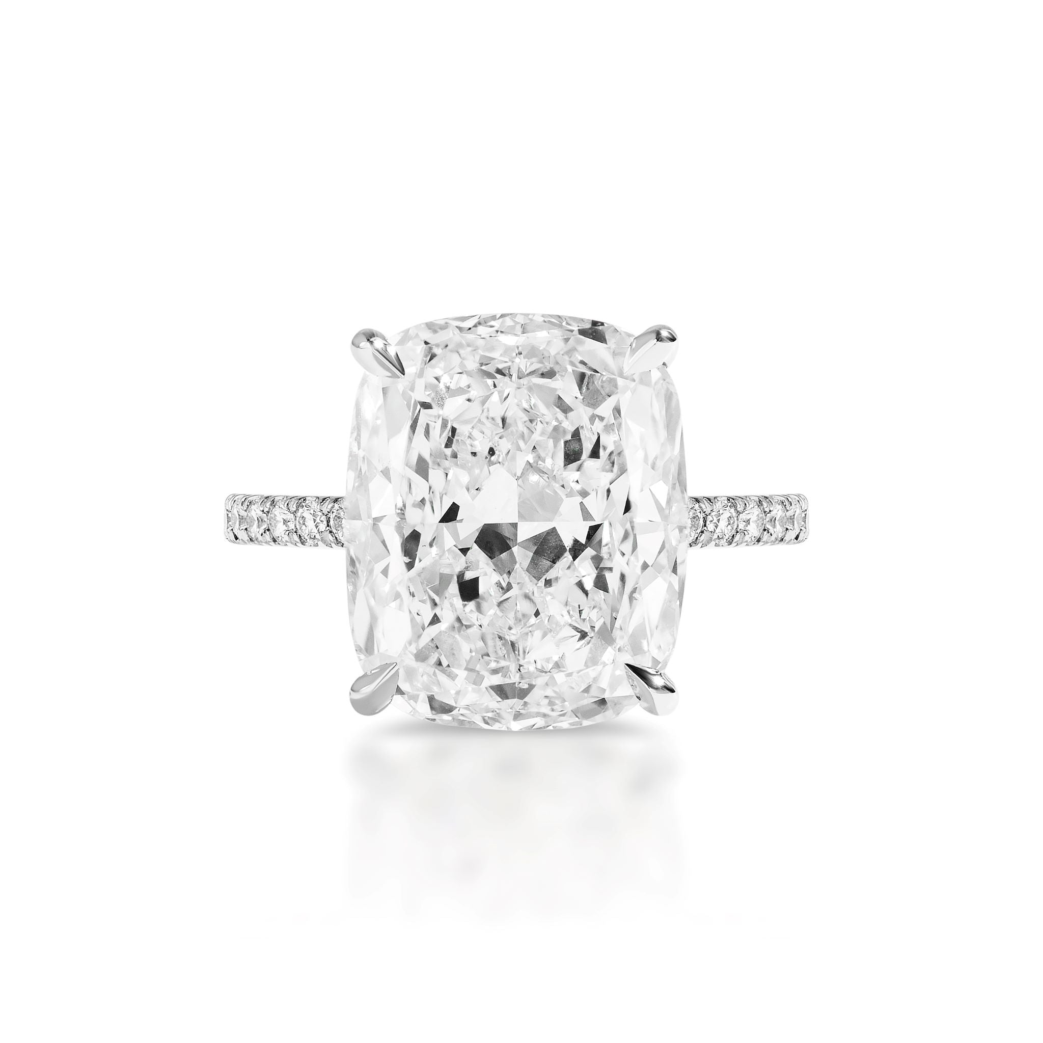 Showcased on a white background, the Cushion Cut Diamond Engagement Ring with Pavé Band features a cushion-cut center diamond surrounded by a halo of smaller diamonds—a bespoke design perfect for celebrating love.