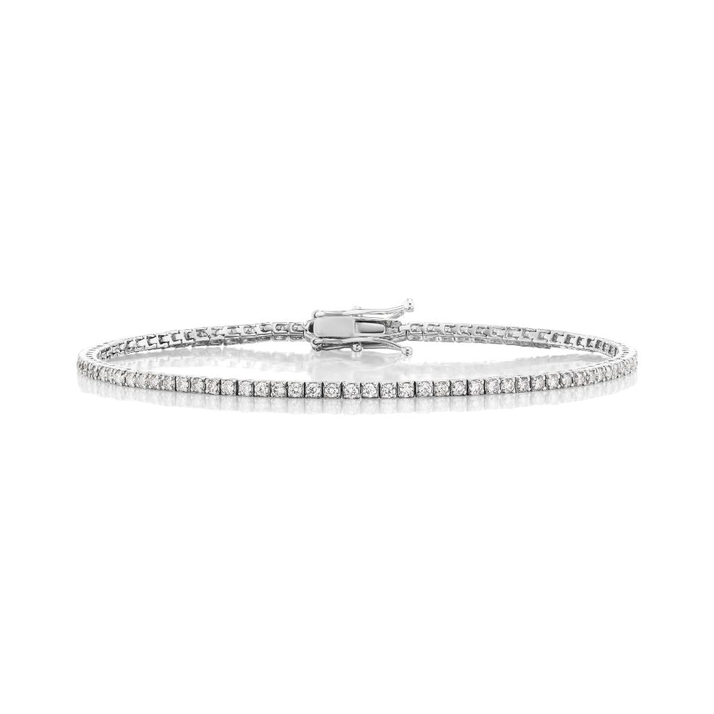 The Skinny Round Brilliant Diamond Tennis Bracelet in white gold features a single row of closely set round brilliant diamonds, displayed against a white background.