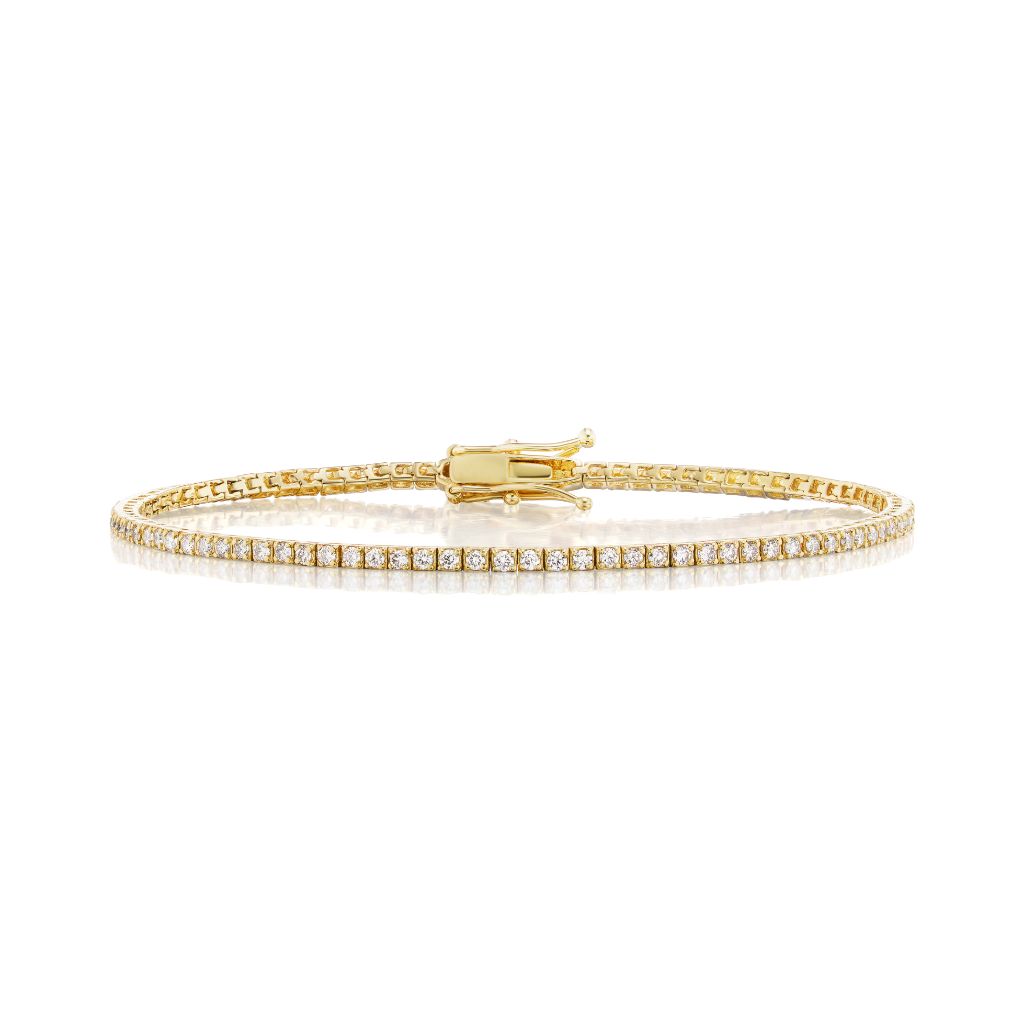 The Skinny Round Brilliant Diamond Tennis Bracelet in white gold features small, evenly spaced round brilliant diamonds and a secure clasp, displayed on a white background.