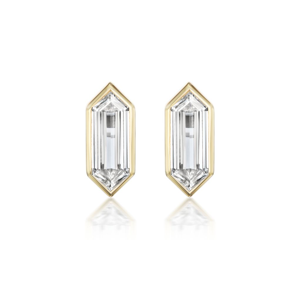 The Bezel Set Studs in Yellow Gold feature elongated hexagonal diamonds set in 18K bezels, displayed on a white background.