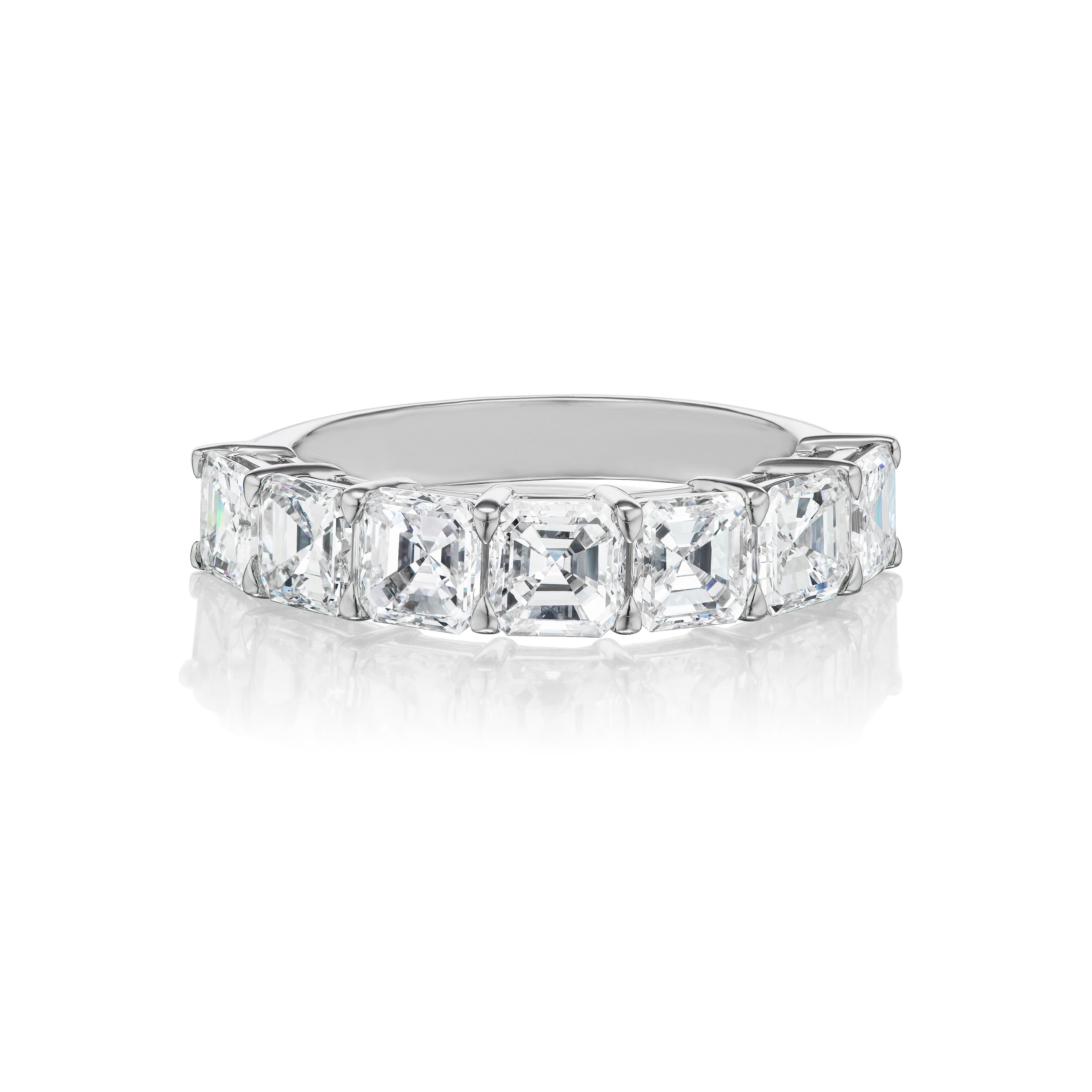 The Asscher Cut Diamond Half Eternity Band showcases large Asscher cut diamonds set in a platinum band, elegantly displayed against a white background.